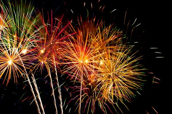 Vibrant Fireworks with Red Yellow and Blue Sparks image