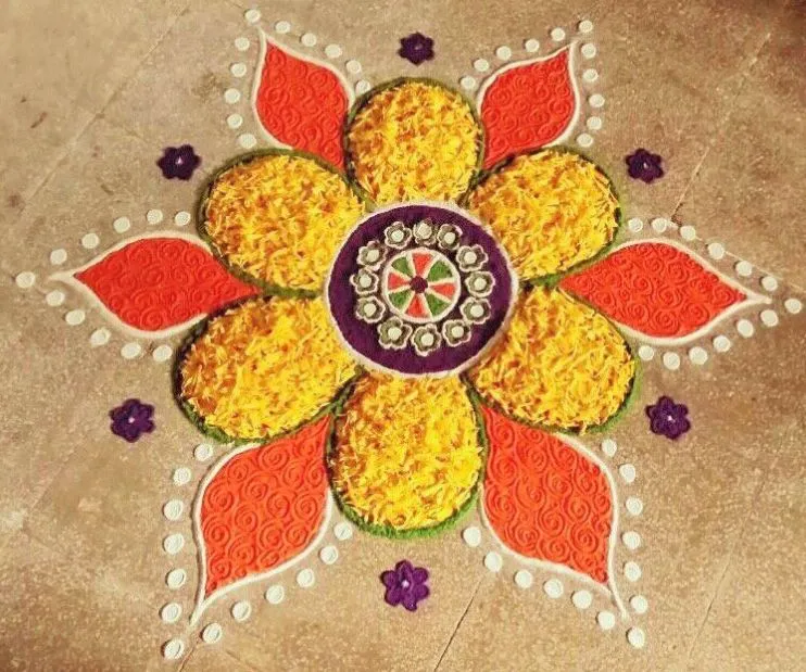 Vibrant flower pookolam with powder and flower petals image