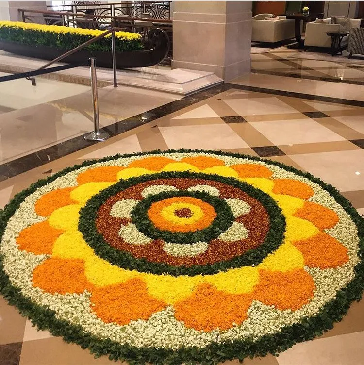 Vibrant rangoli with yellow and orange petal design image
