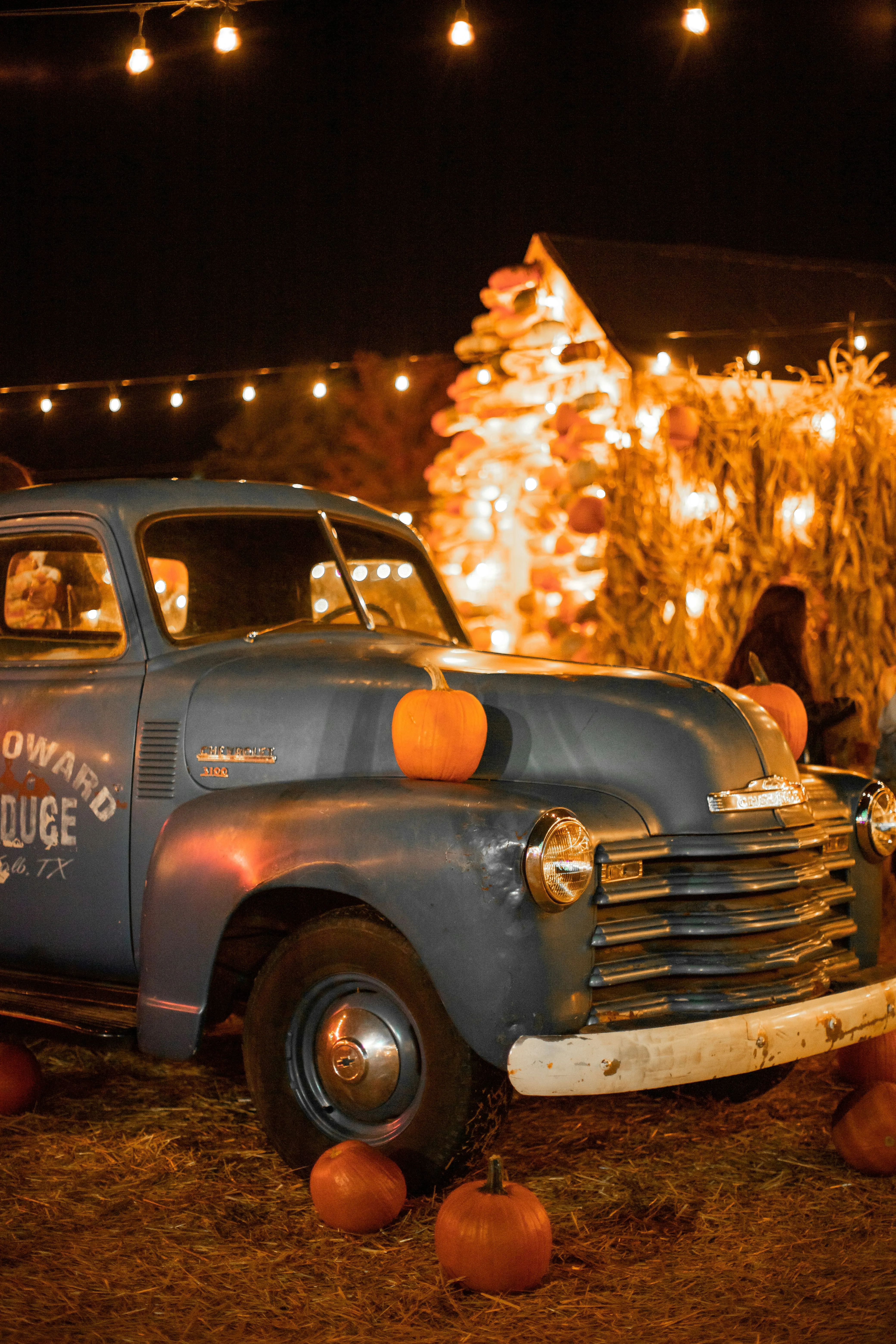 Vintage Truck with Pumpkins and Halloween Lights Wallpaper