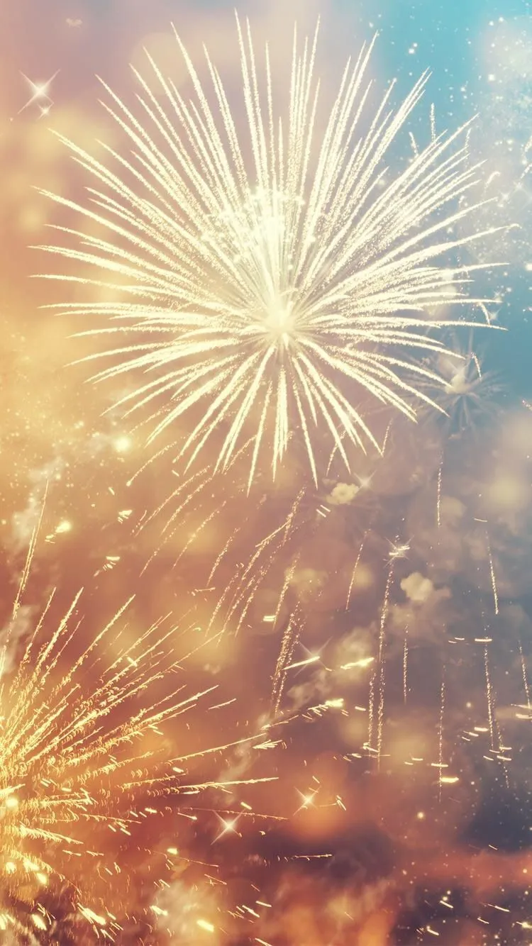 Warm Golden Fireworks in the Sky with Soft Glow Wallpaper