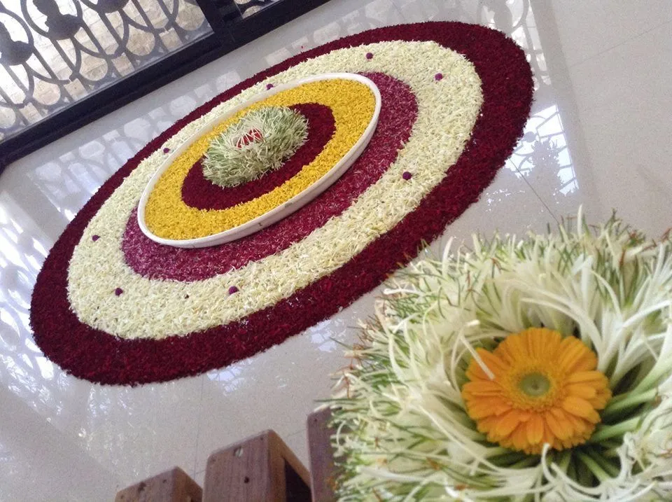 White and maroon concentric circle Onam pookolam design