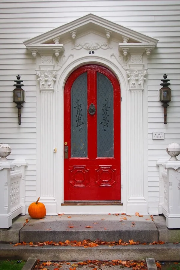 White House Entrance with Bright Red Door and Pumpkin Decor