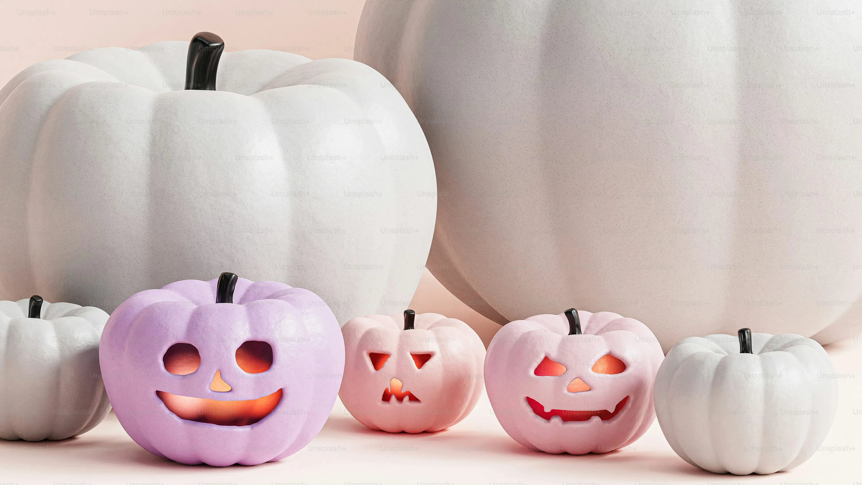 White Pumpkins and Mini Carved Pumpkins on White Background