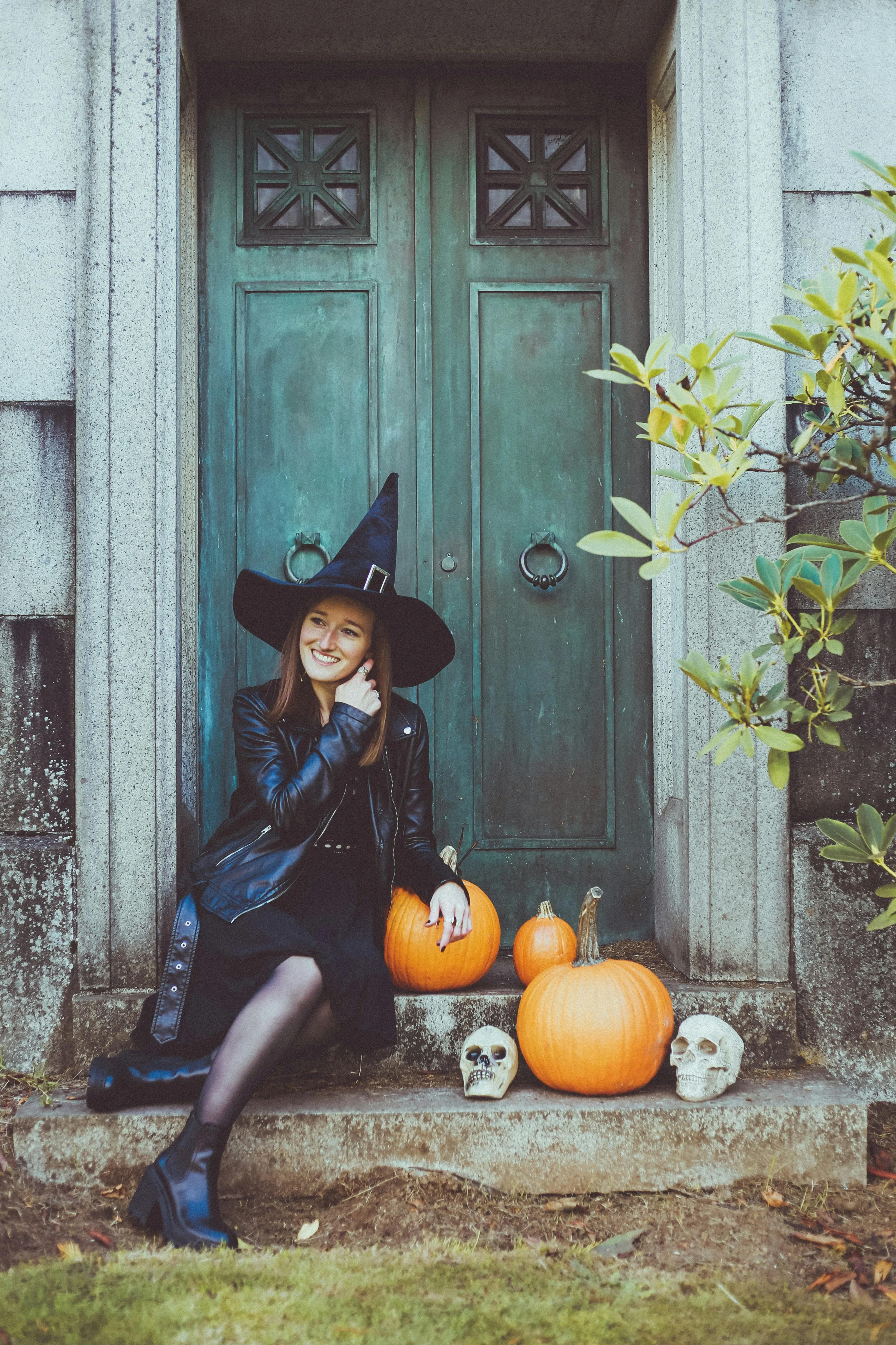 Witch Sitting near Door with Pumpkins at Festival image