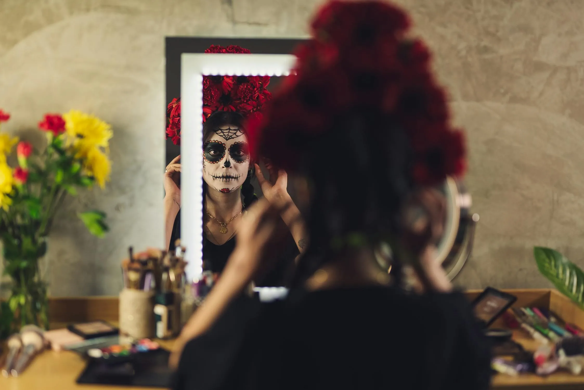 Woman Fixing Halloween Makeup in Mirror Reflection Wallpaper