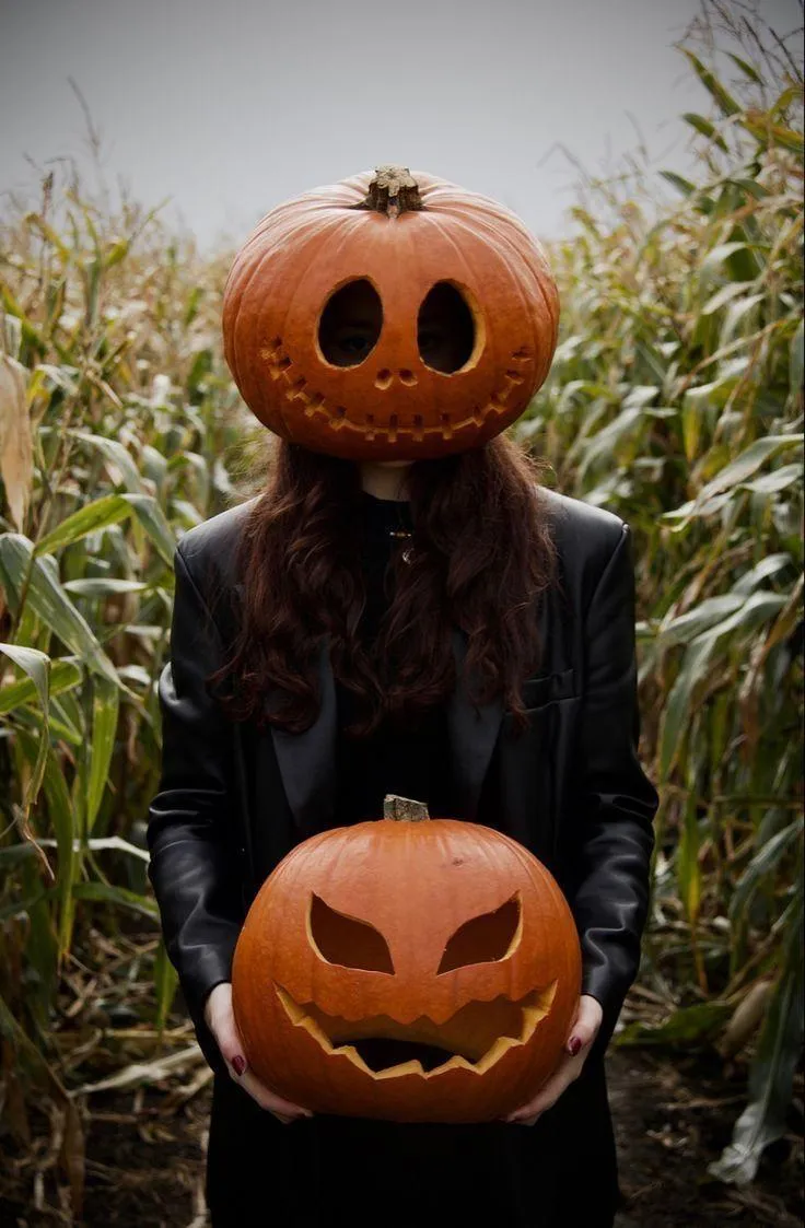 Woman Holding Jack o Lantern Pumpkin on Outside image