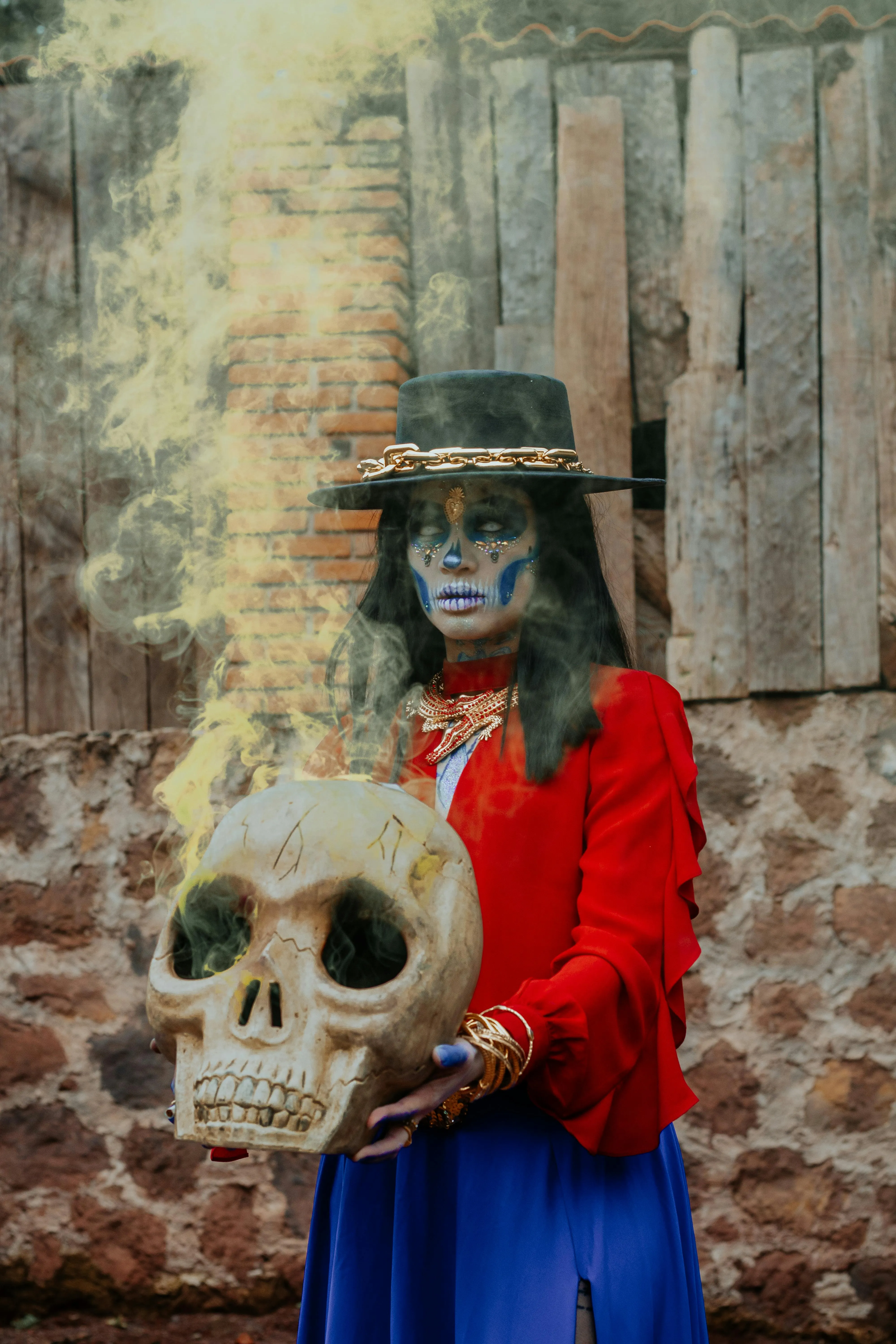 Woman Holding Large Skull Prop in Red Dress Wallpaper