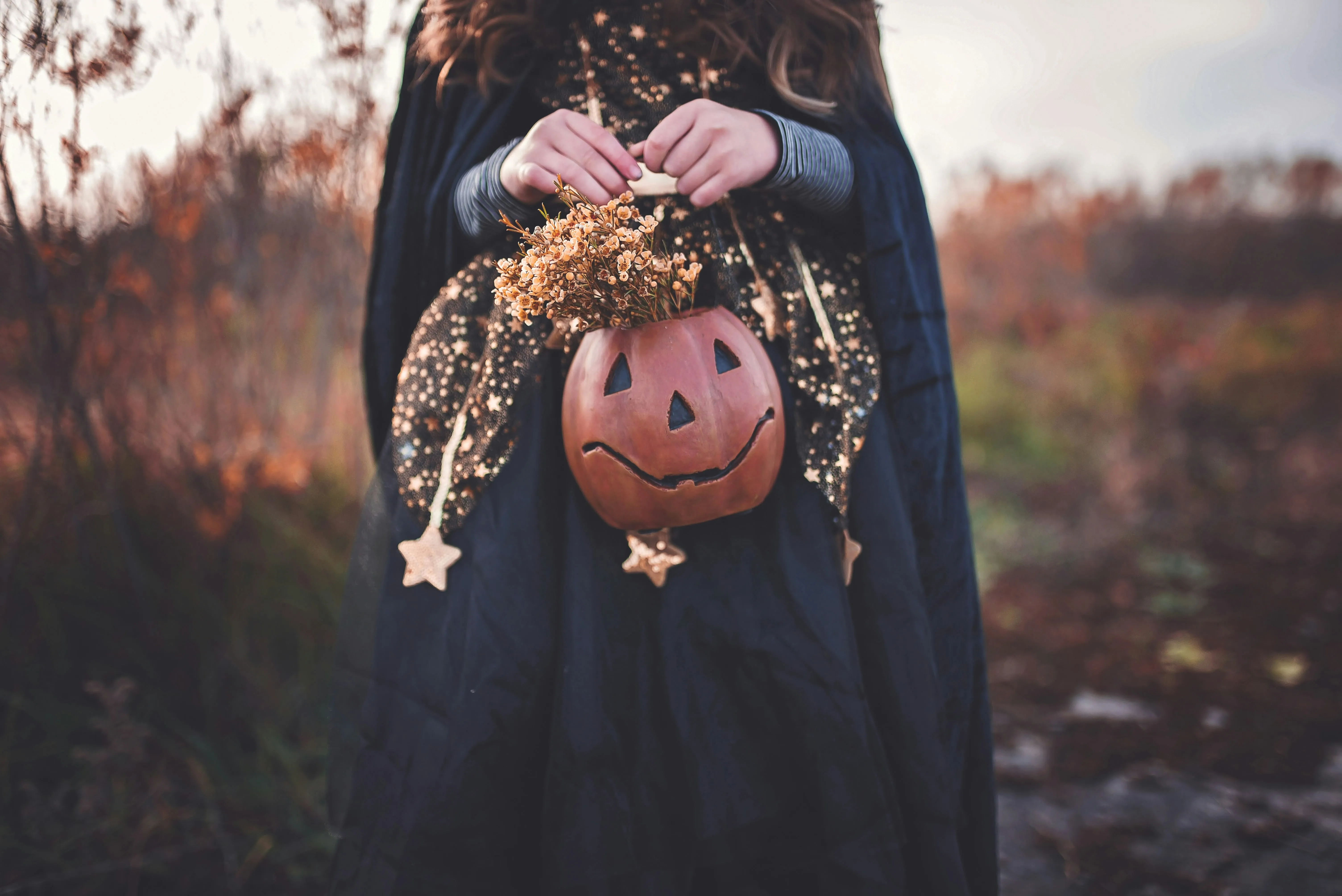 Woman Holding Pumpkin Basket in Halloween Festival image