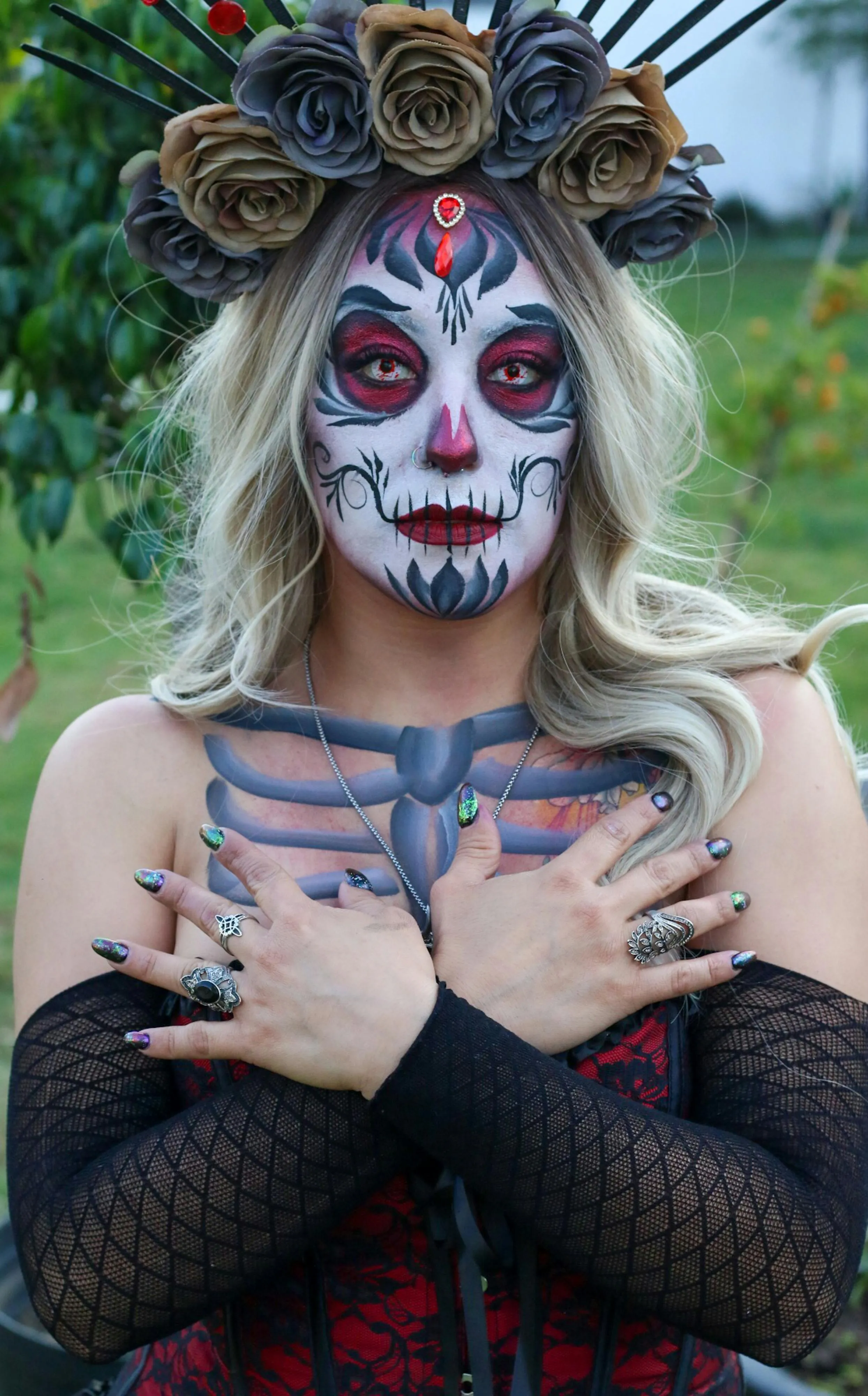 Woman in Black Dress with brown rose Crown and Skull Makeup