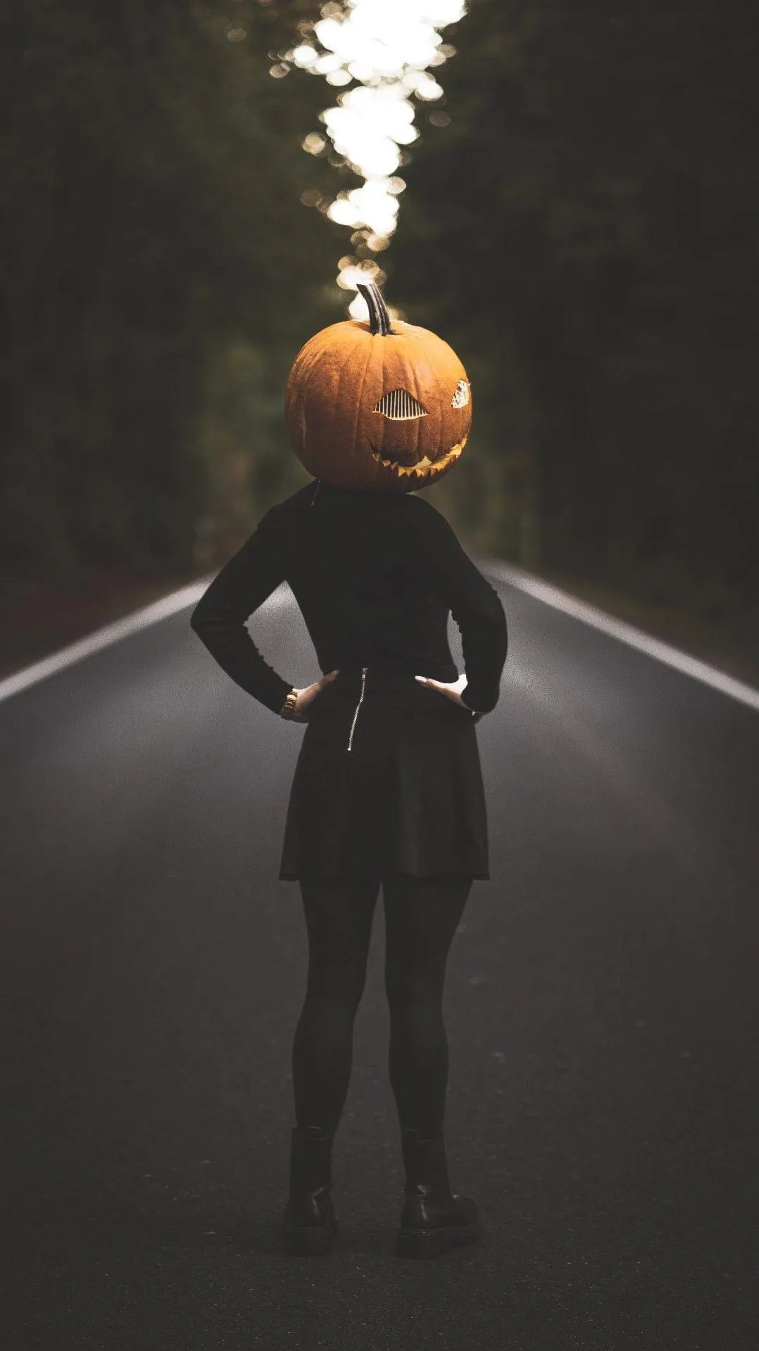 Woman in Black Dress with Pumpkin on Head on Road Wallpaper