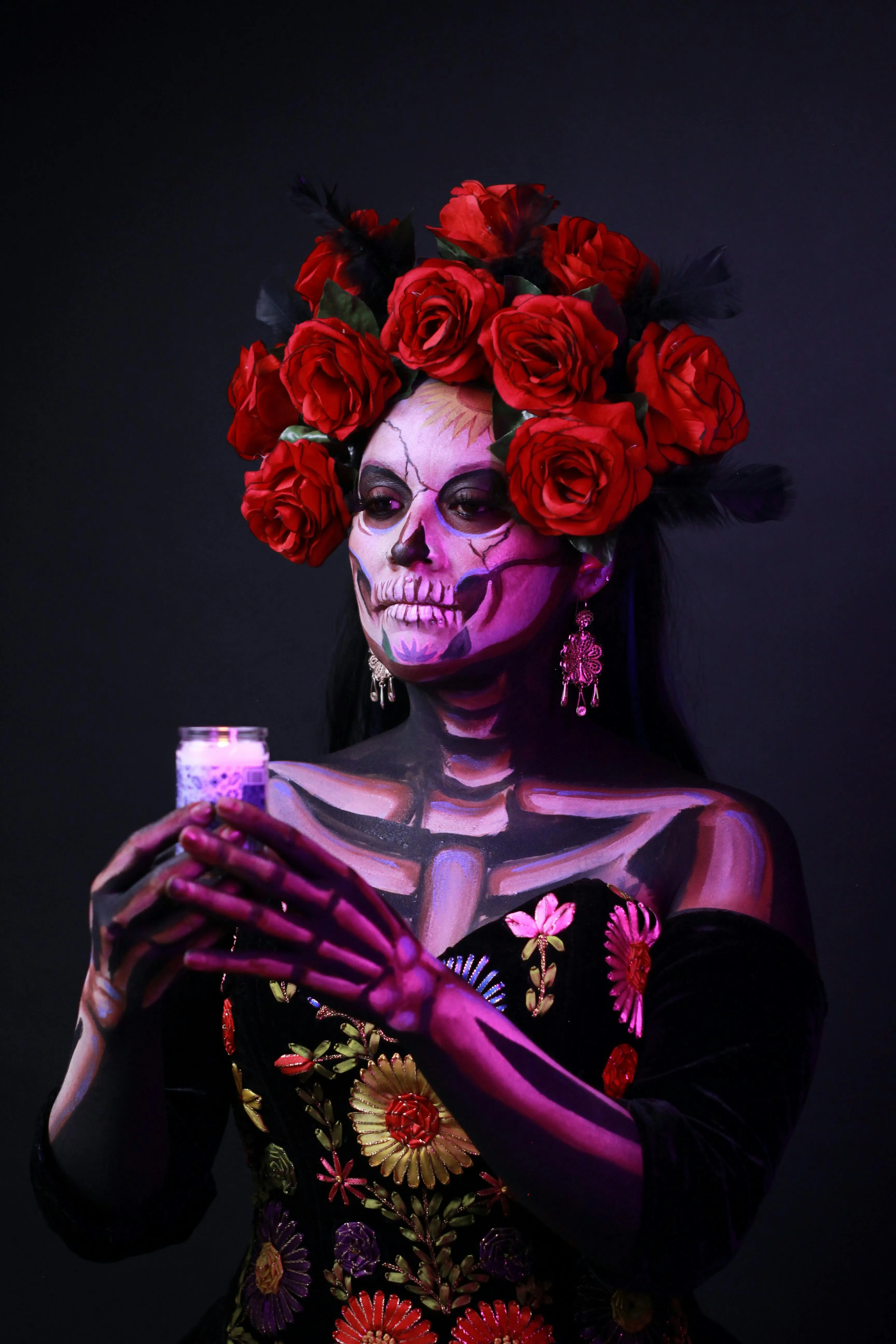 Woman in Black Dress with Purple Skull Makeup and Roses