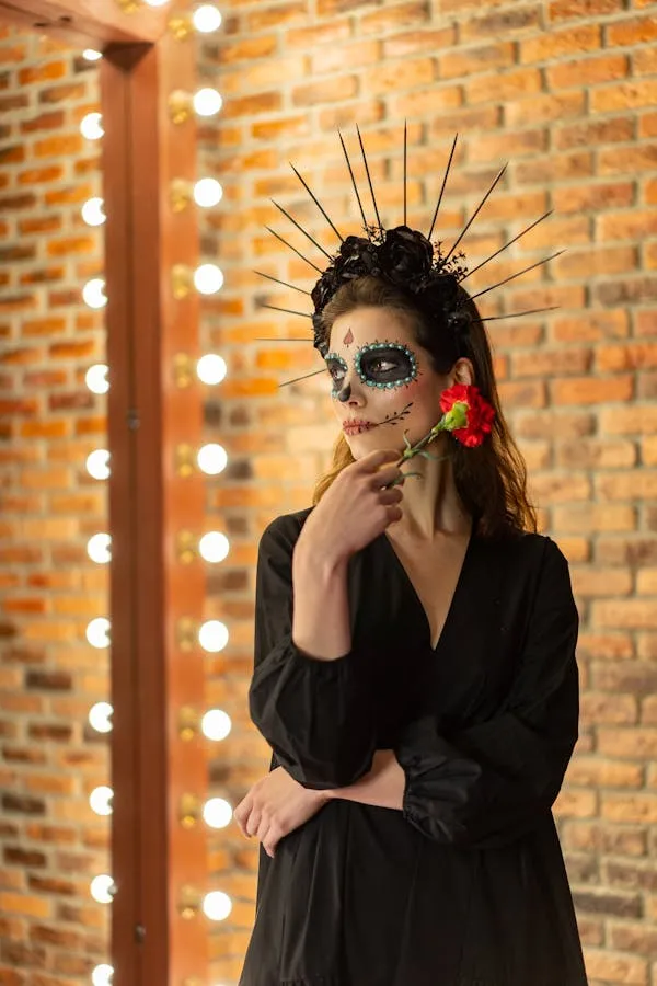 Woman in black outfit with spooky makeup and golden light