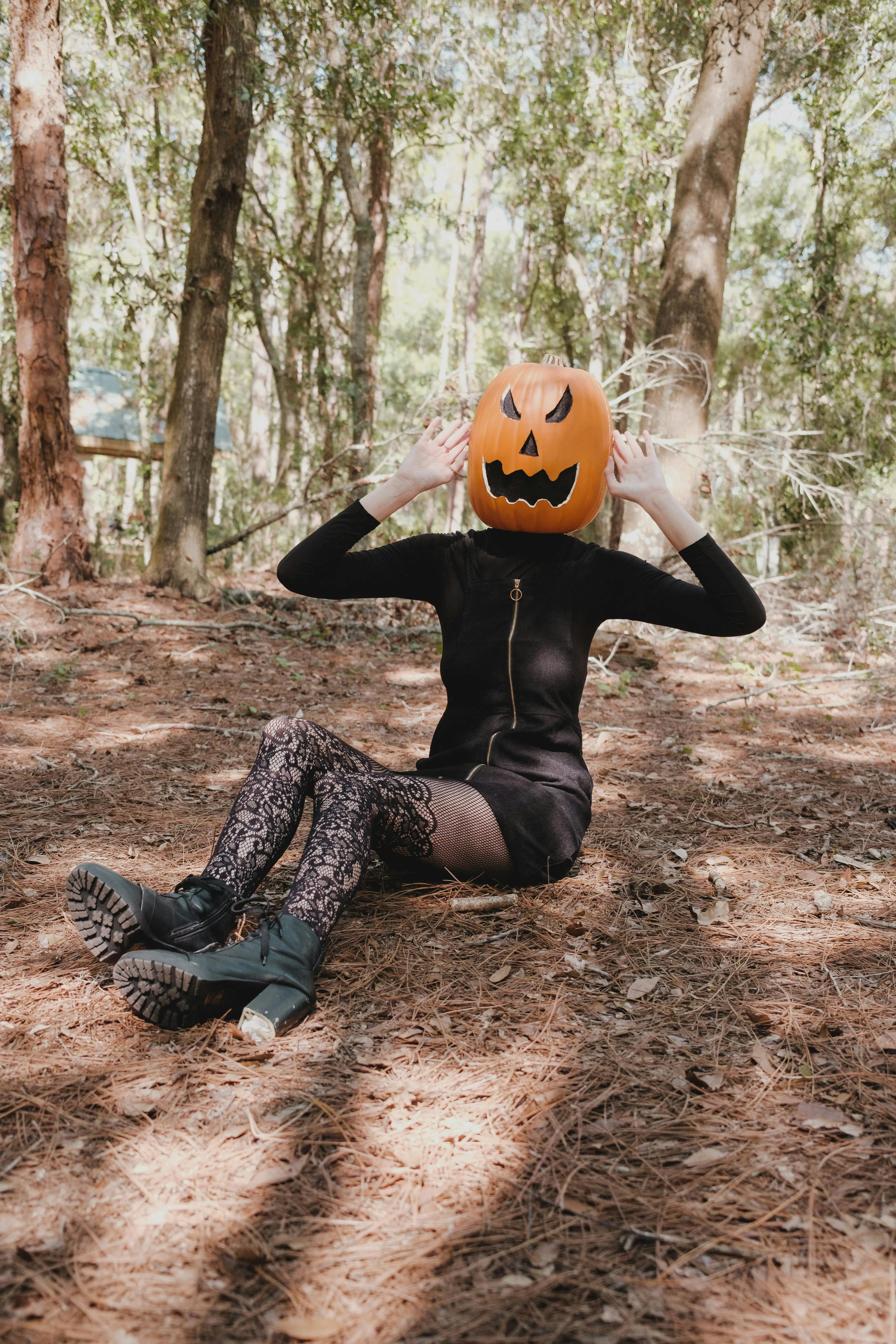 Woman in Black Witch Costume Posing in Forest Wallpaper