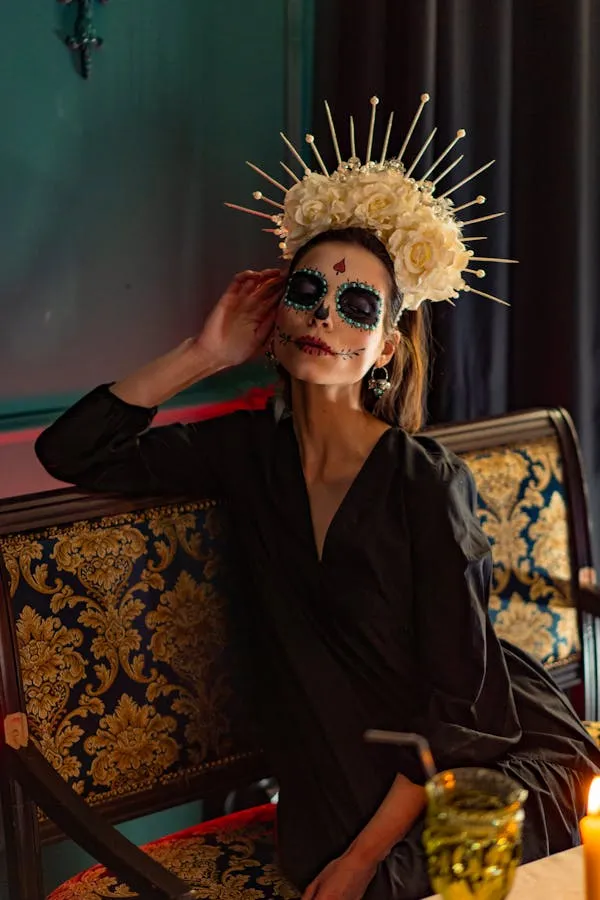 Woman in crown and makeup sitting on couch in dark room