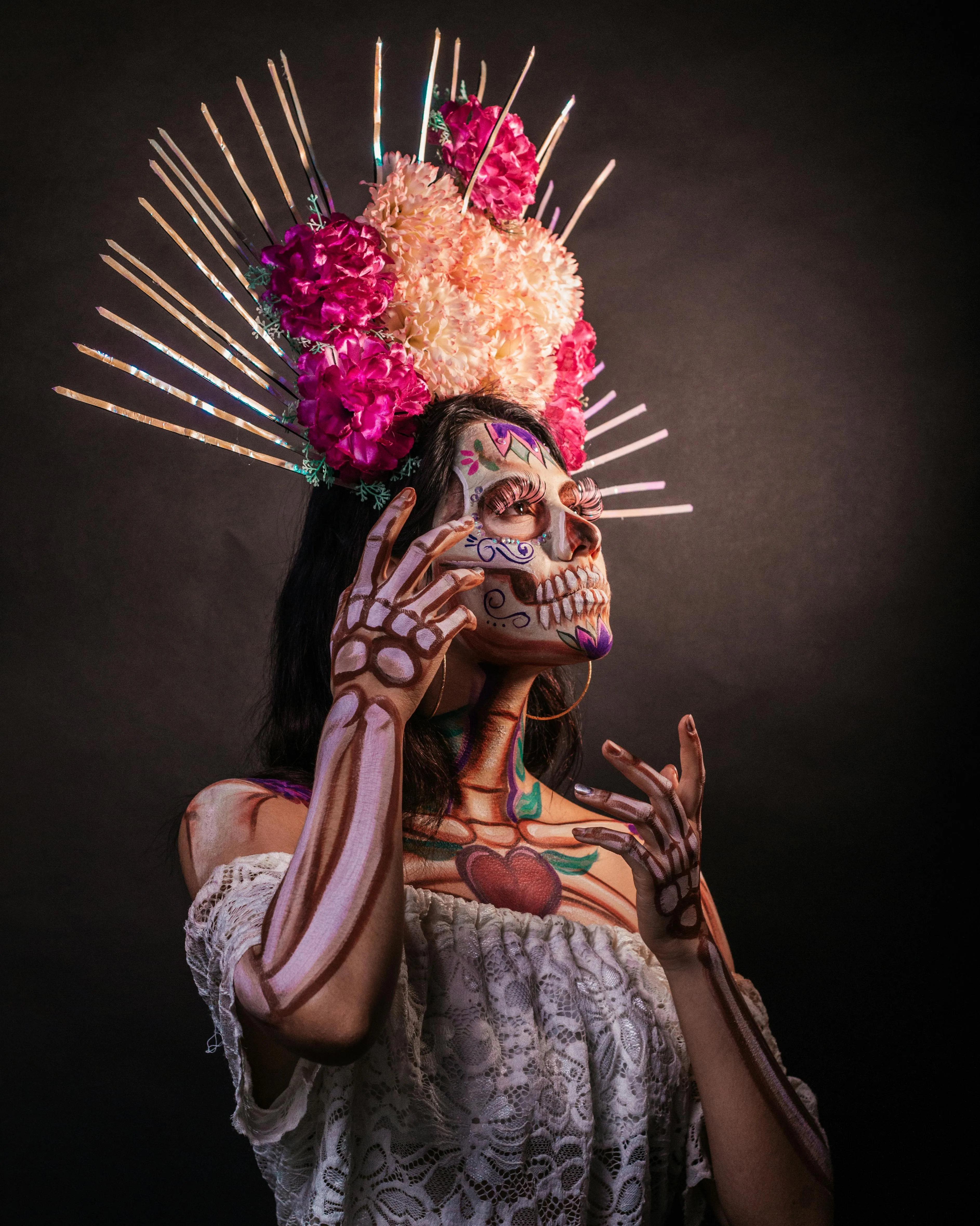 Woman in Crown and Skull Makeup Under Pink Spotlight image