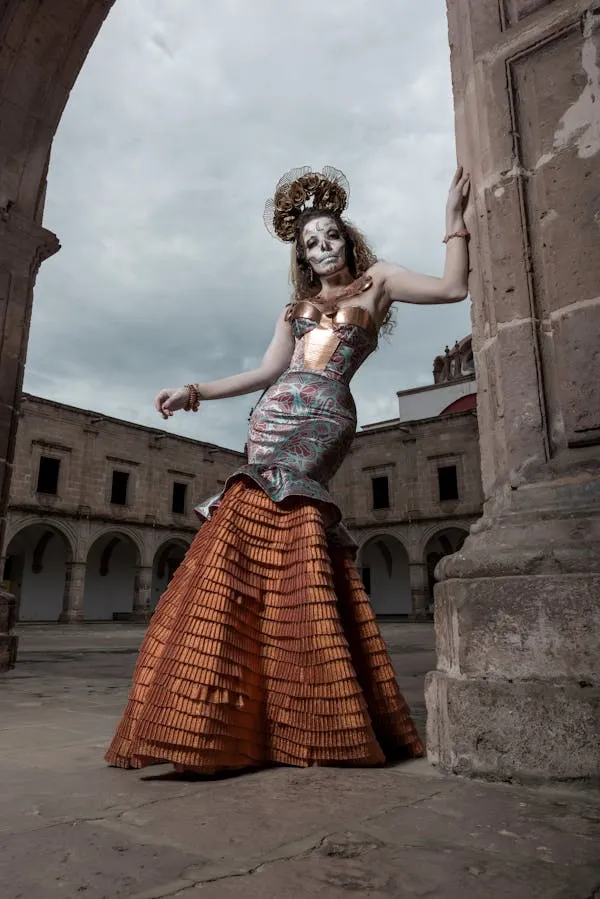 Woman in Day of the Dead Dress Poses in Courtyard Wallpaper