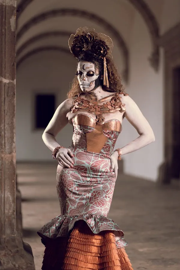 Woman in detailed skeleton dress with white face paint
