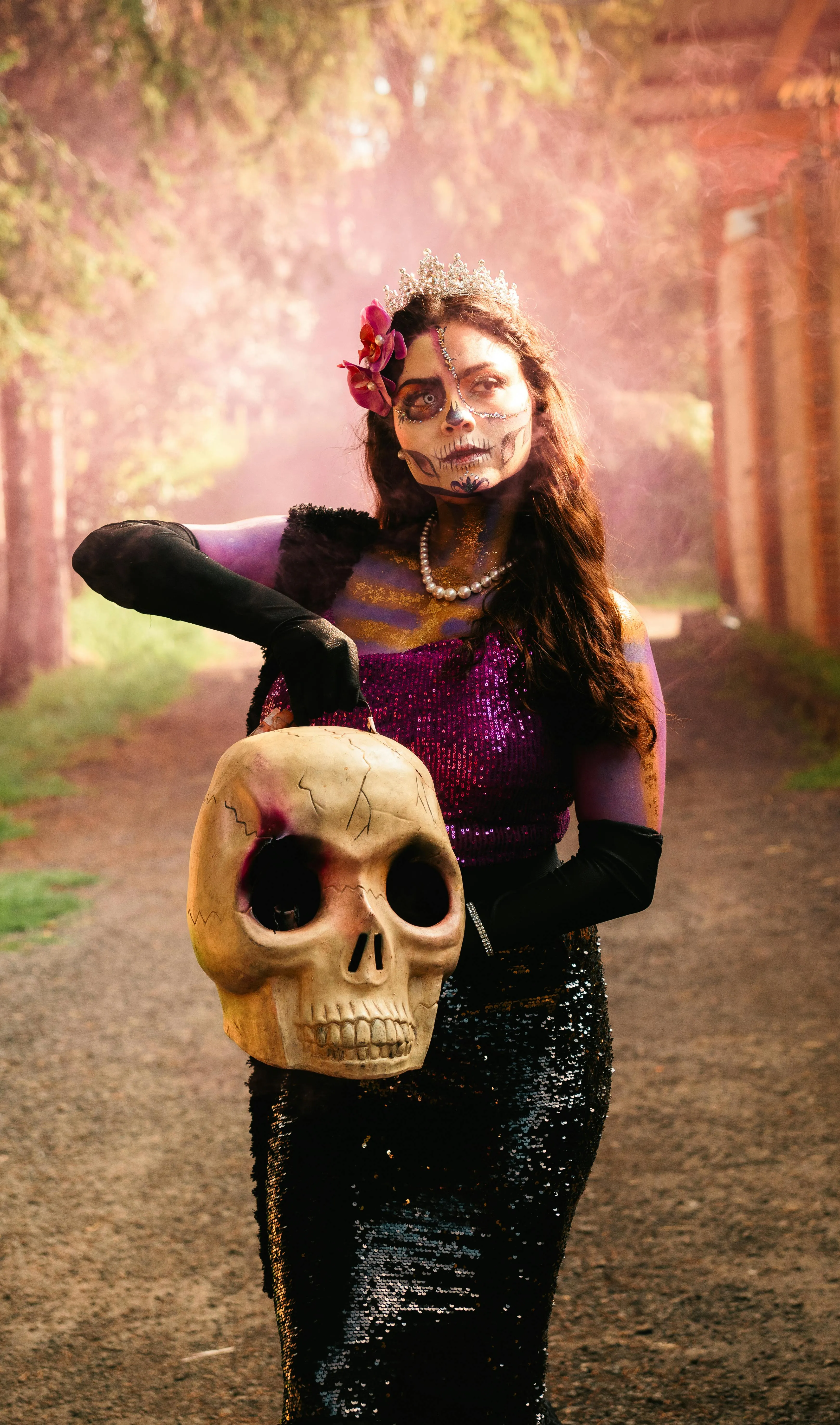 Woman in Devil Costume Holding Giant Skull free Wallpaper