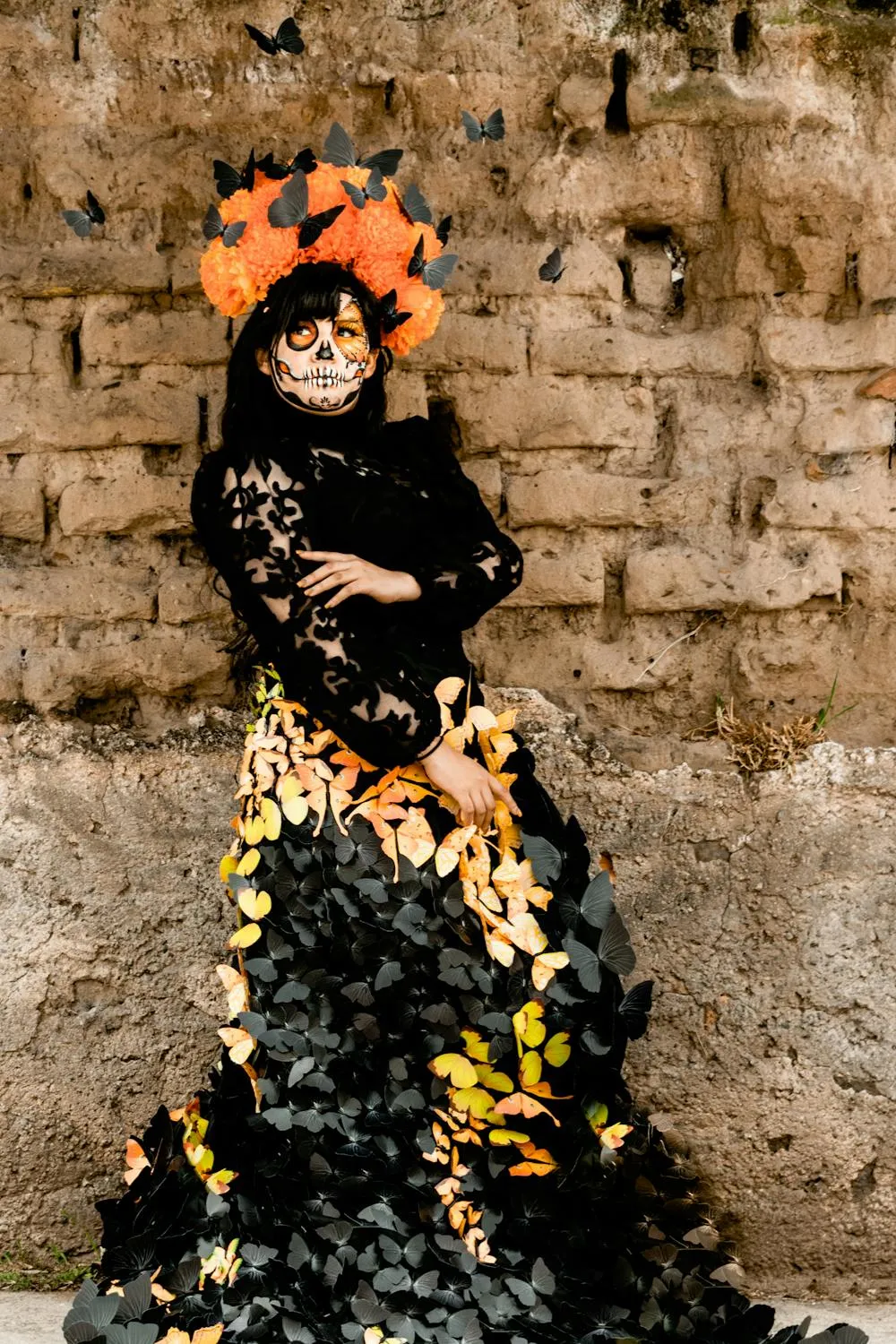 Woman in Floral Pumpkin Dress Posing Against Stone Wall
