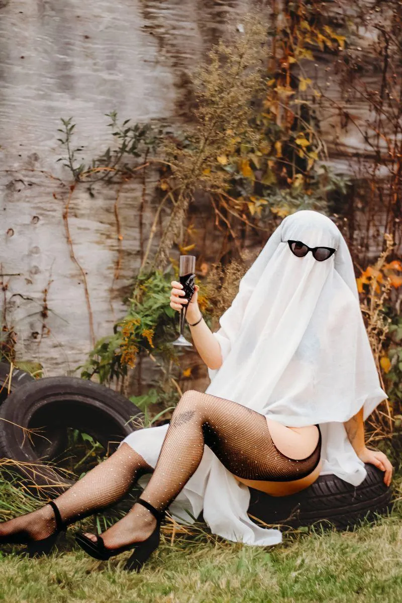 Woman in Ghost Costume Relaxing on an Tire image HD