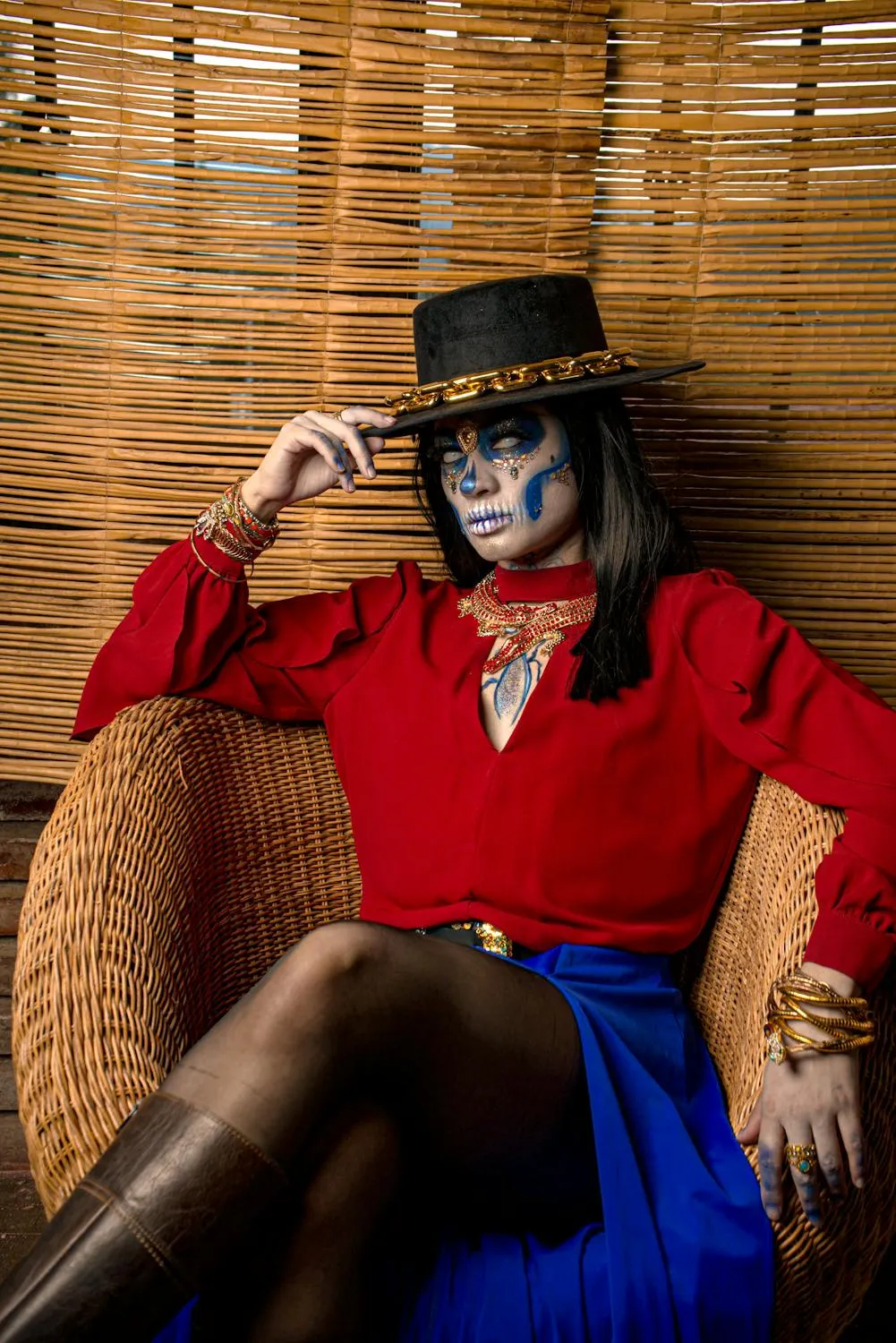 Woman in Skeleton Makeup and Costume Sitting on Wicker Chair