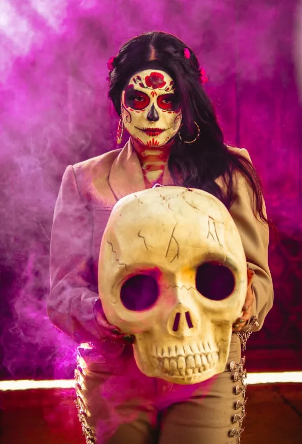 Woman in skull makeup with pink smoke on Halloween image