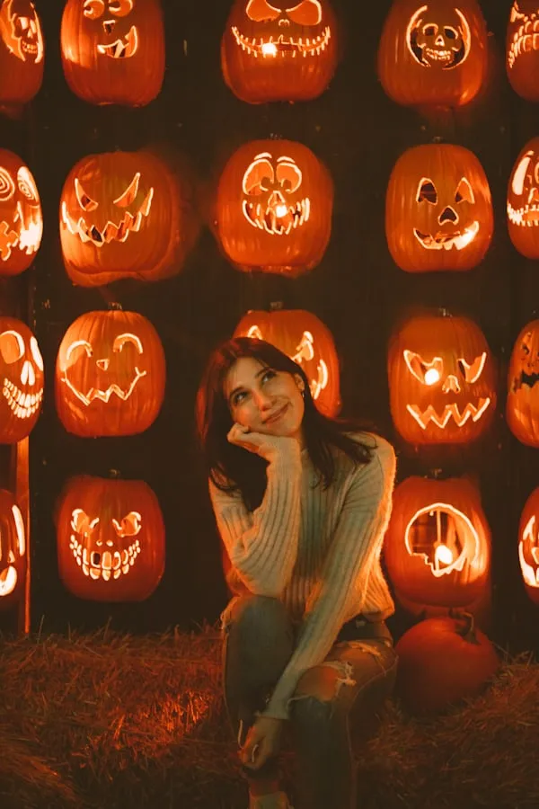 Woman Posing Among Halloween Carved Pumpkins Wallpaper