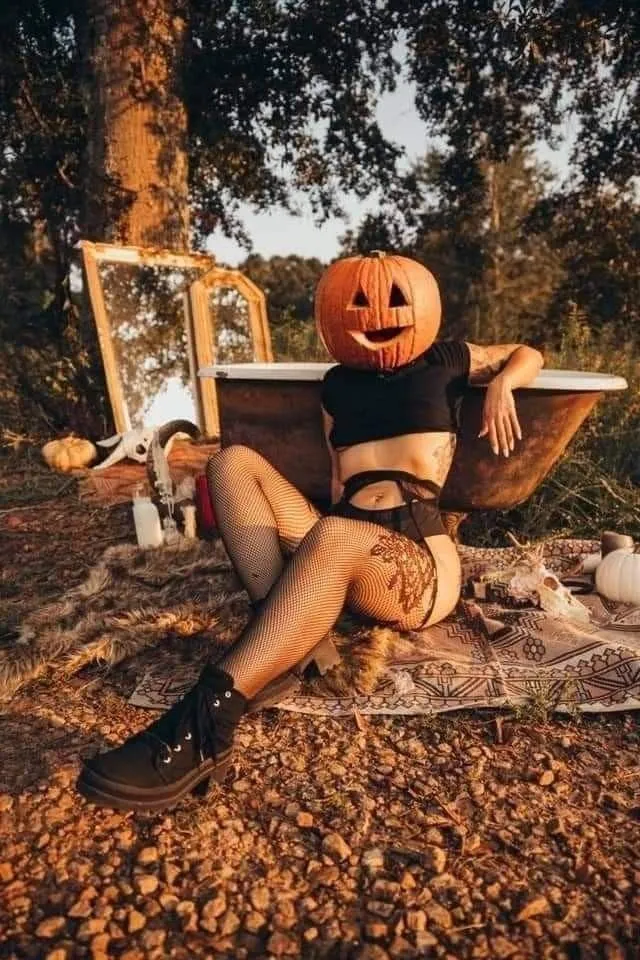 Woman Relaxing with Pumpkin Head on Autumn Day Wallpaper