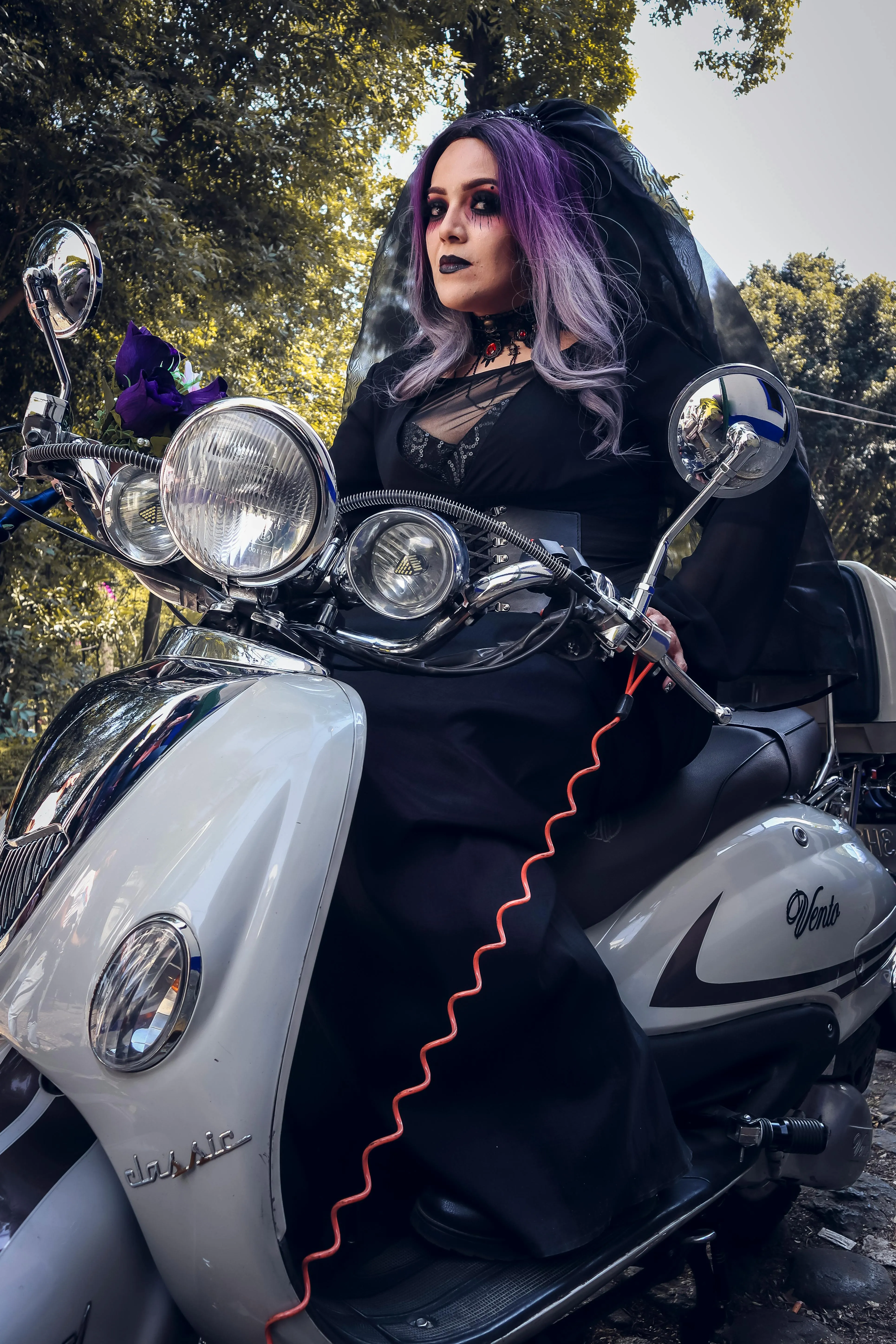 Woman Riding Scooter in Halloween Costume at Night Wallpaper
