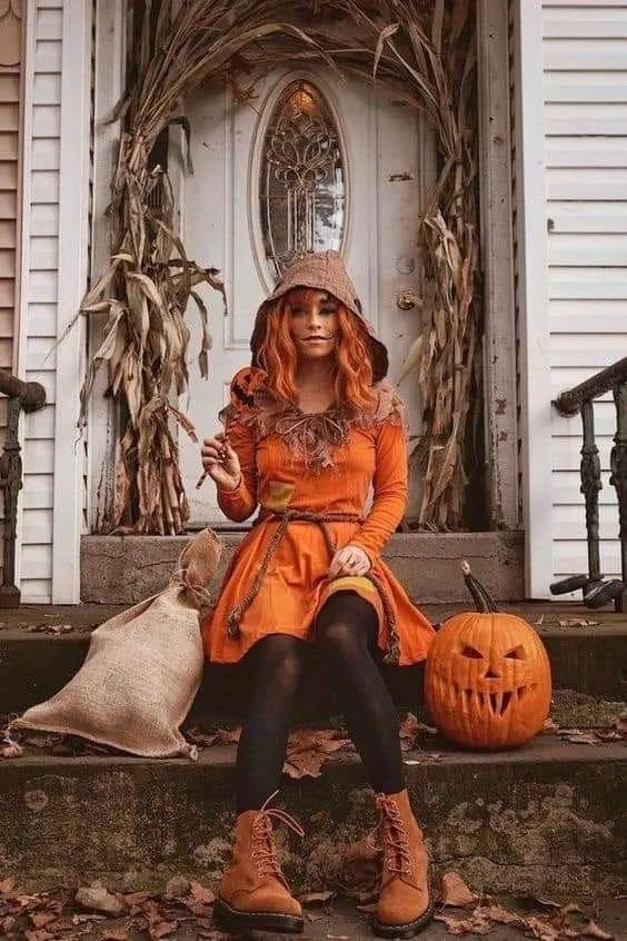 Woman Sitting on Porch with Halloween Pumpkins Wallpaper
