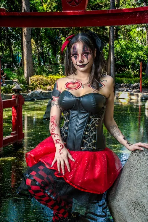 Woman Wearing Black and Red Halloween Costume near Pond