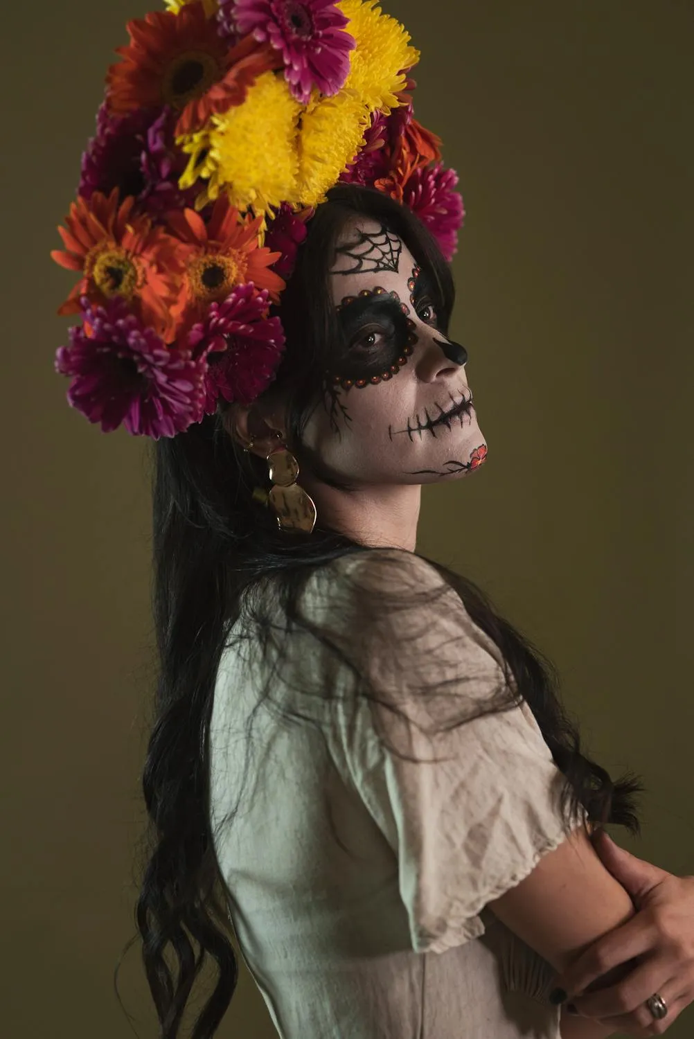 Woman Wearing Halloween Makeup and Flower Crown Profile View