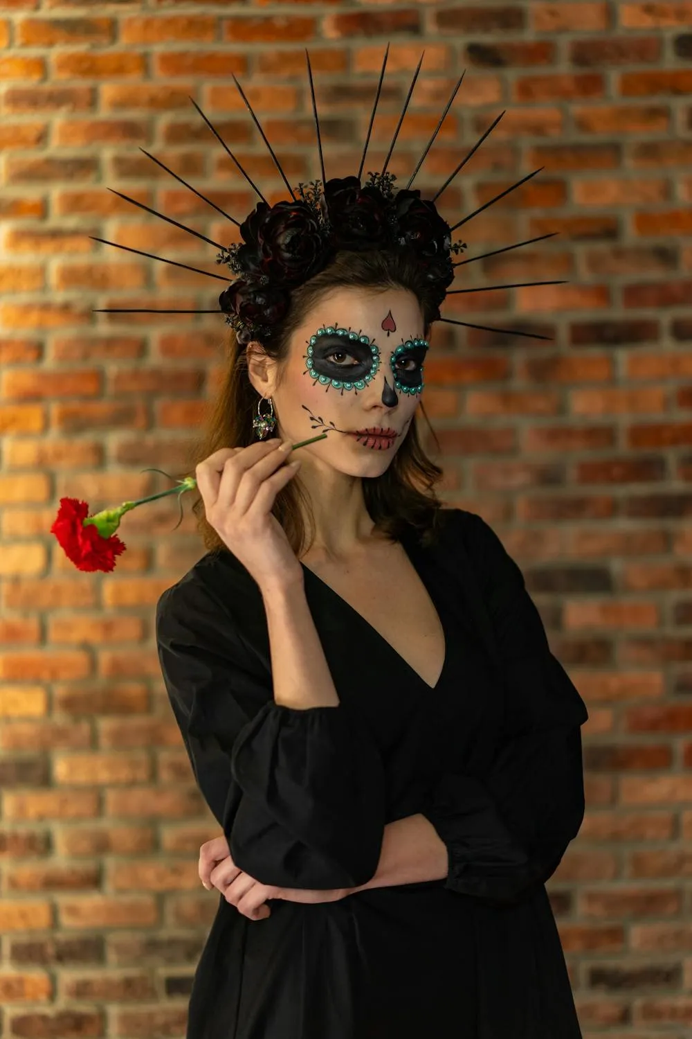Woman Wearing Halloween Makeup Holding Red Rose Wallpaper