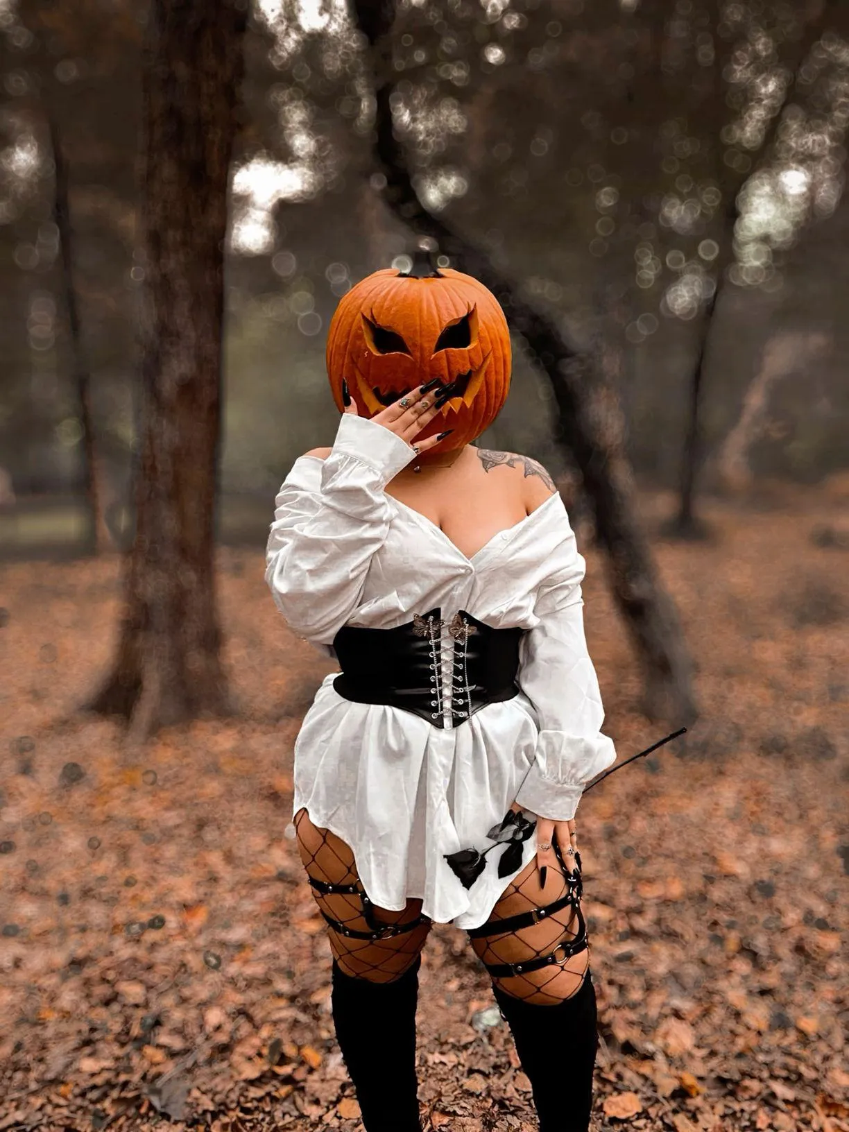 Woman Wearing Pumpkin Head and White Dress Posing in Autumn