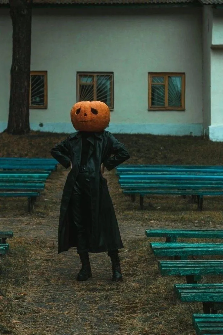 Woman Wearing Pumpkin Head Mask Standing Near Bench