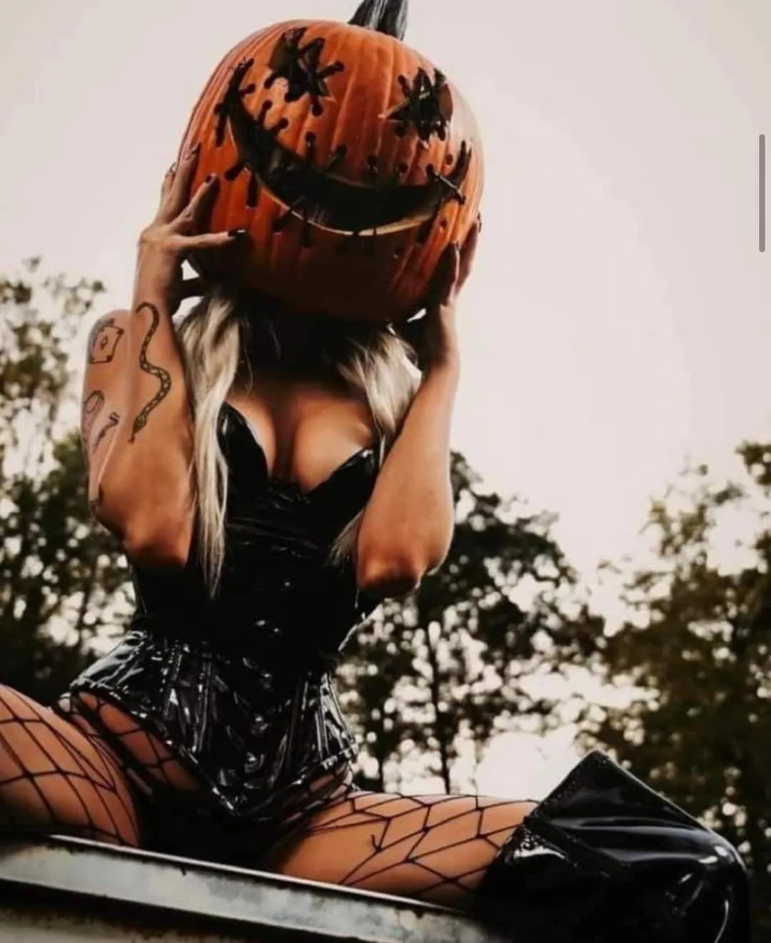 Woman Wearing Pumpkin Headpiece in Autumn Forest Setting