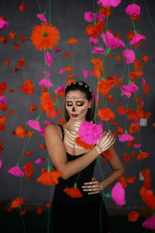 Woman with colorful flowers around her face at Halloween