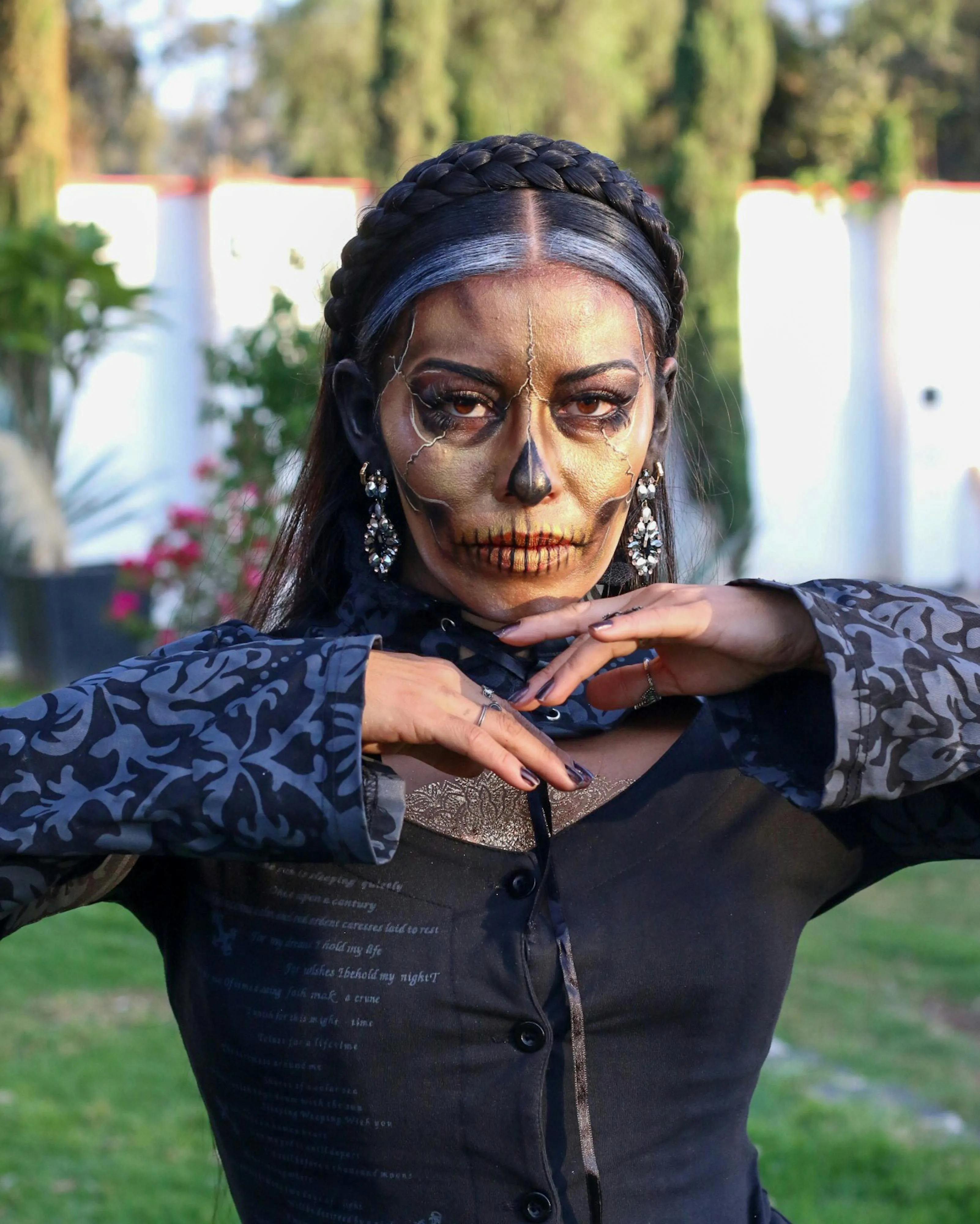 Woman with Dark Skeleton Face Makeup in Garden Wallpaper