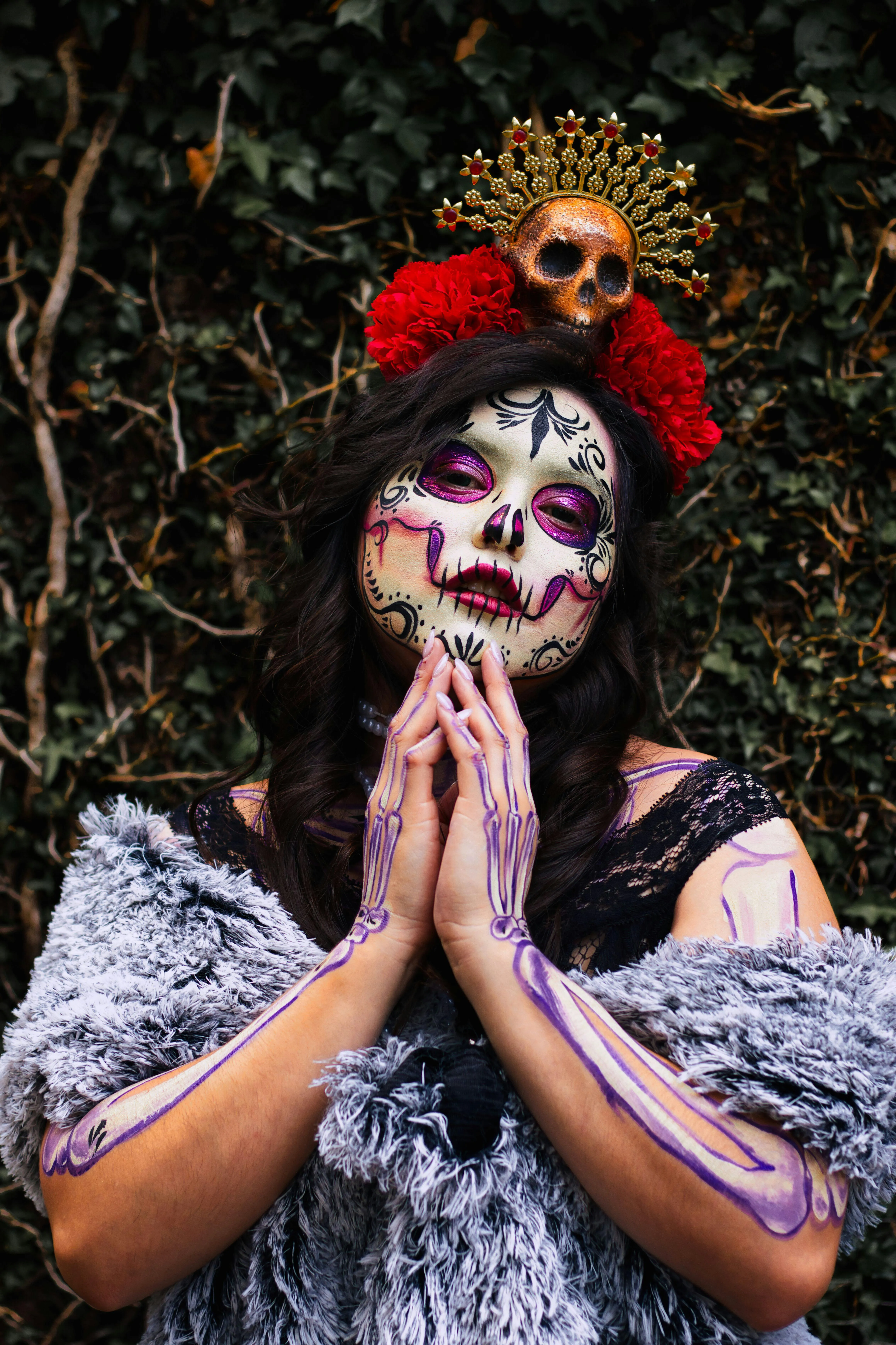 Woman with Face Paint in Prayer Pose at Day of the Dead