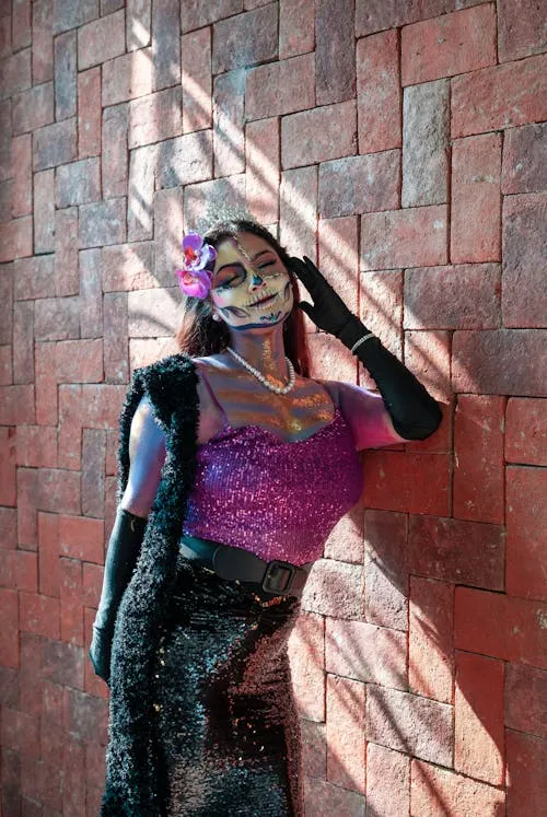 Woman with Mermaid Makeup and Skeleton Skirt on Red Wall