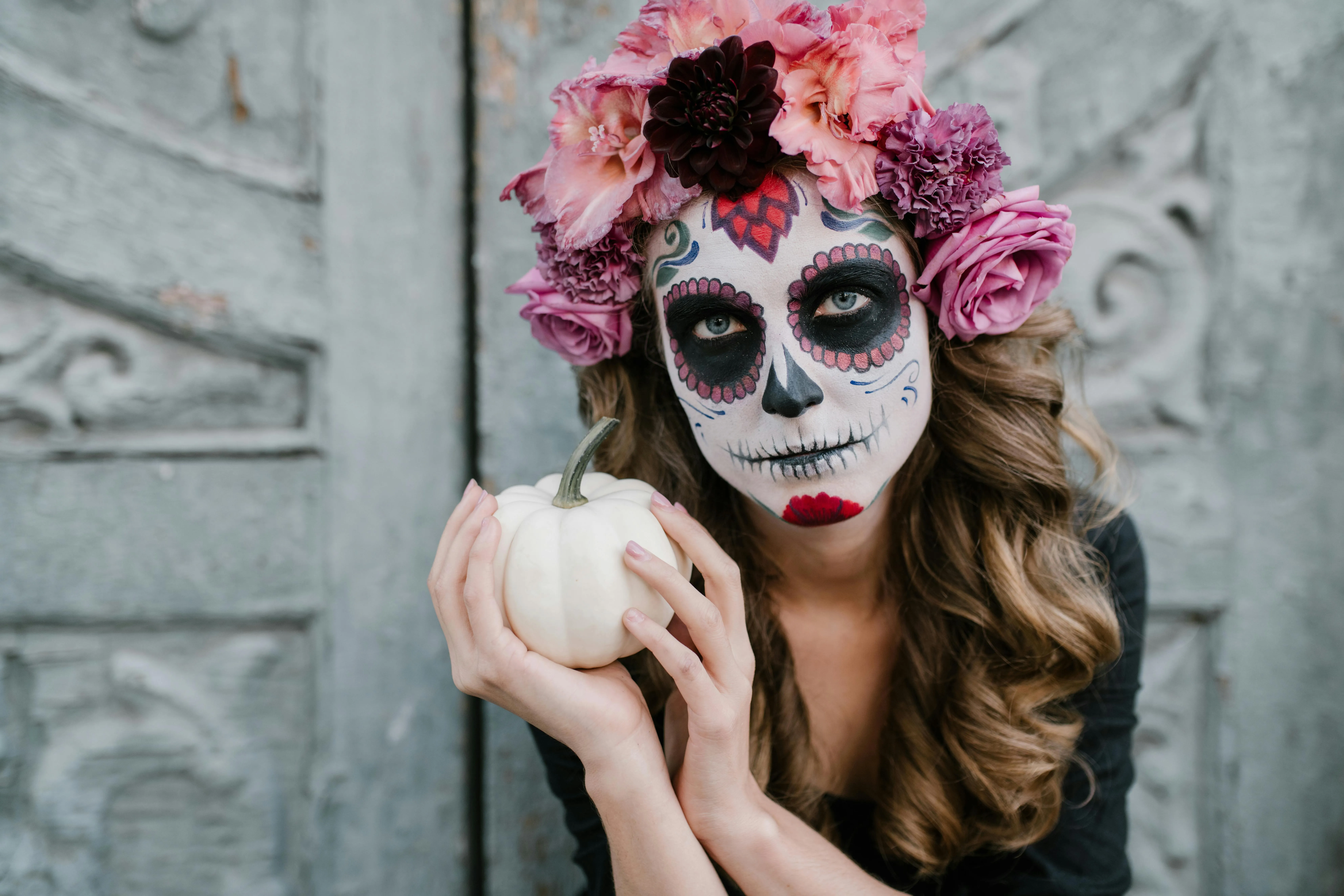 Woman with Pink Roses and Halloween Skull Face Paint