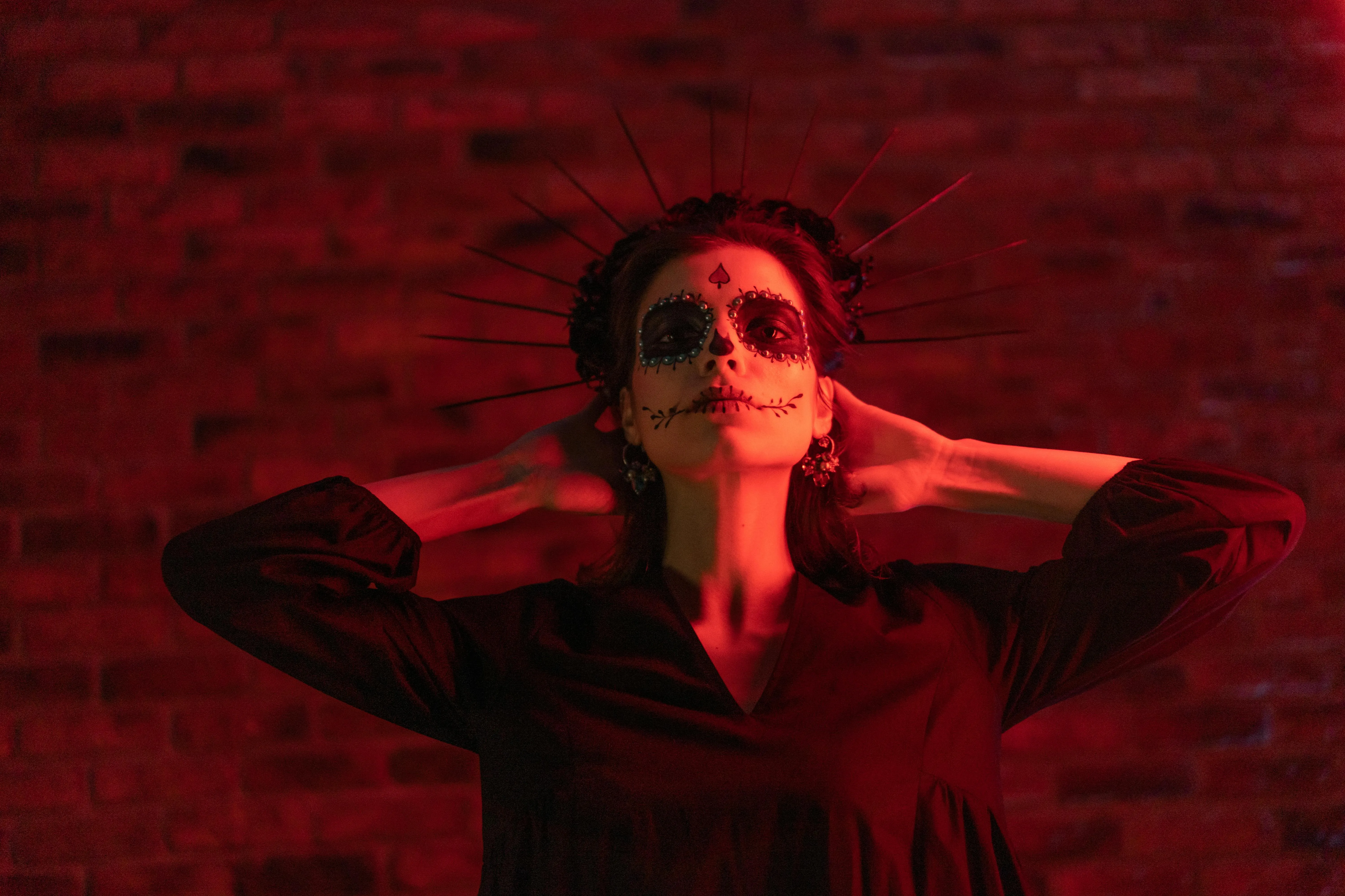 Woman with Red Background and Halloween Makeup image