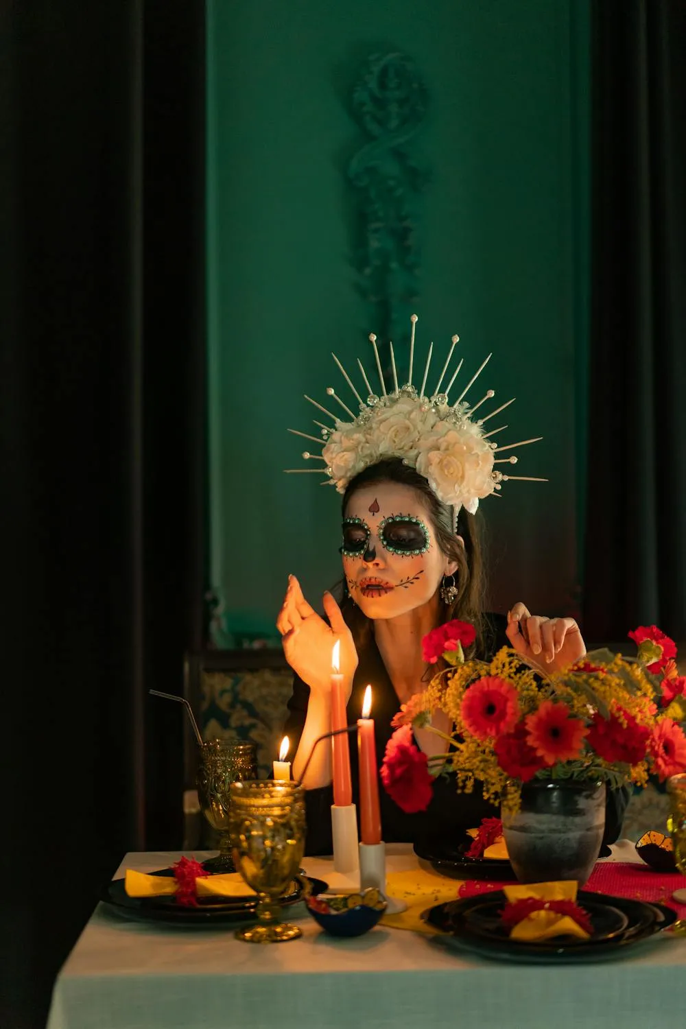 Woman with Skull Makeup and Candle in a Dark Room Wallpaper
