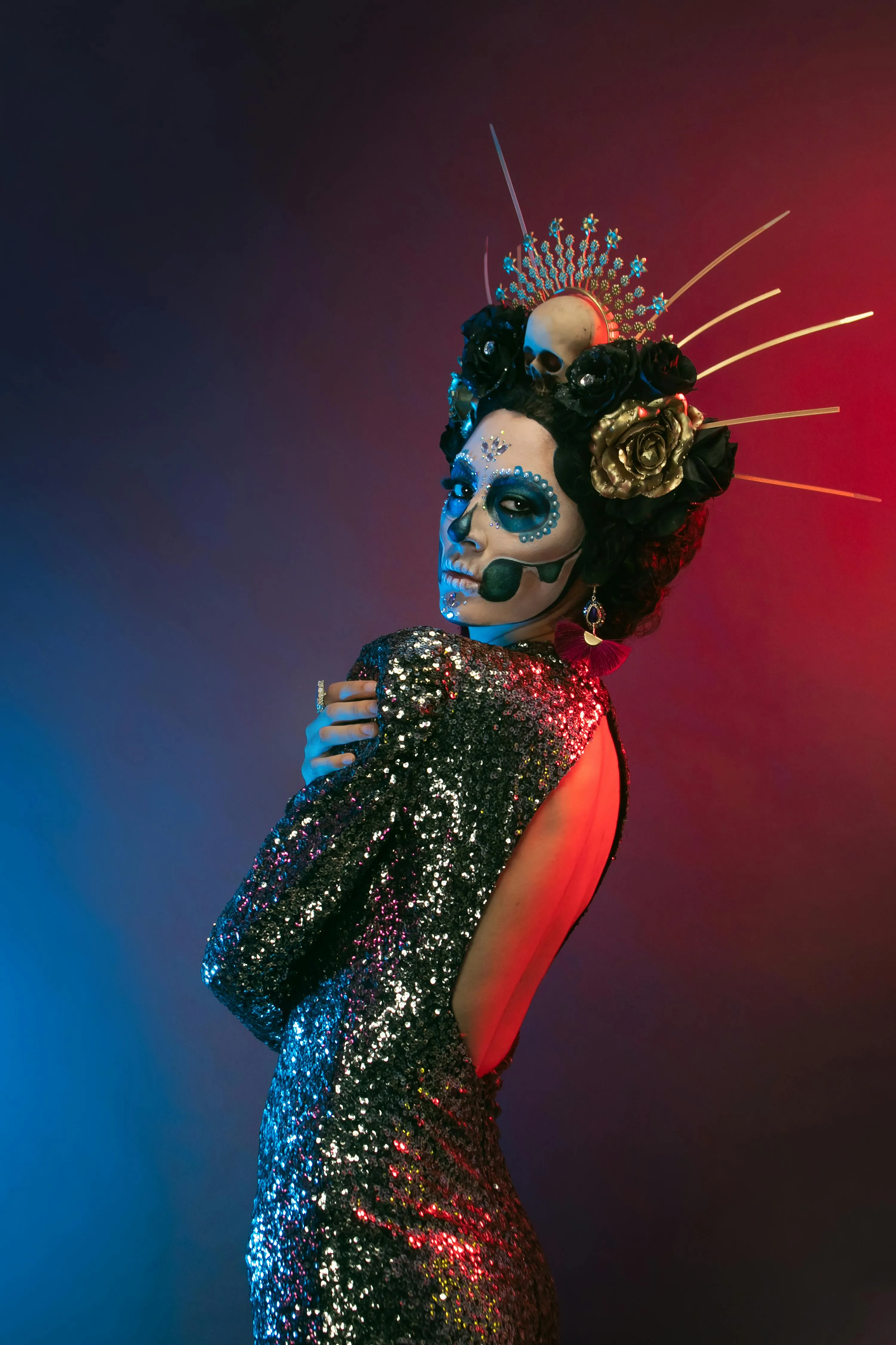 Woman with Spiked Headpiece and Skull Makeup on Dark Background