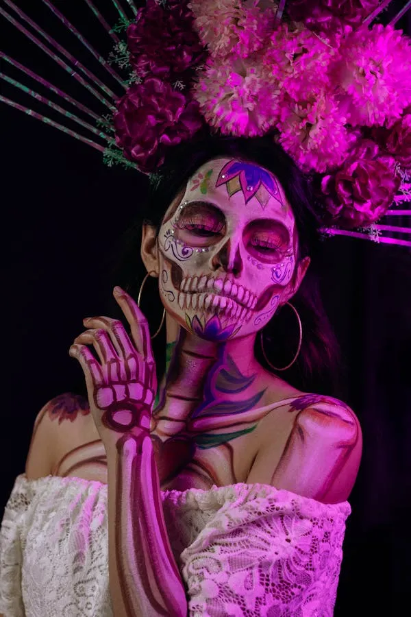 Woman with Sugar Skull Makeup and Pink Flowers for Halloween