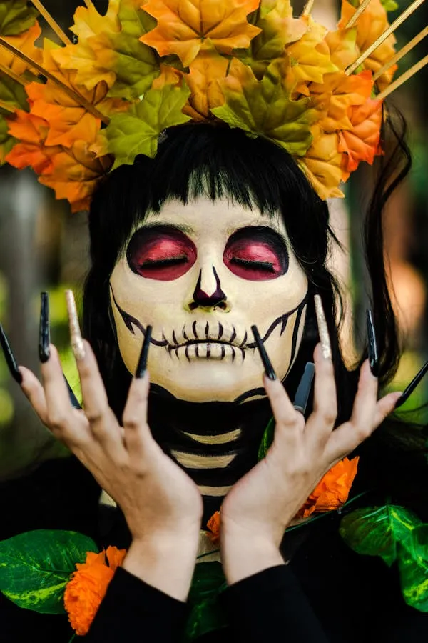 Women in Halloween Makeup with Skull Design and long nails