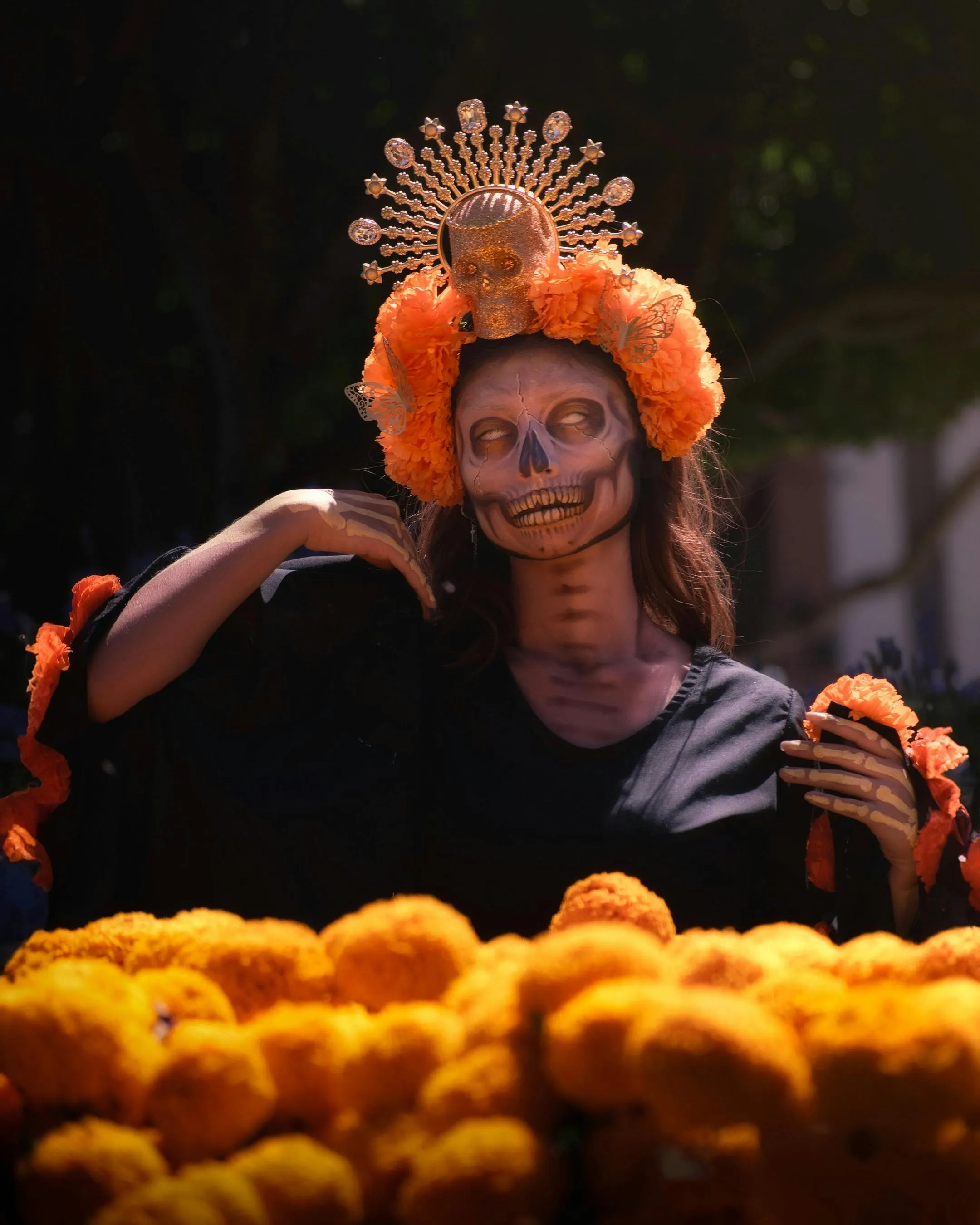 Women in Haloween Makeup with Crown in Marigold Garden