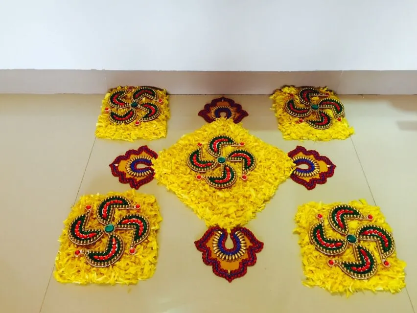 Yellow floral pookolam with Decorative Swastika Motifs HD
