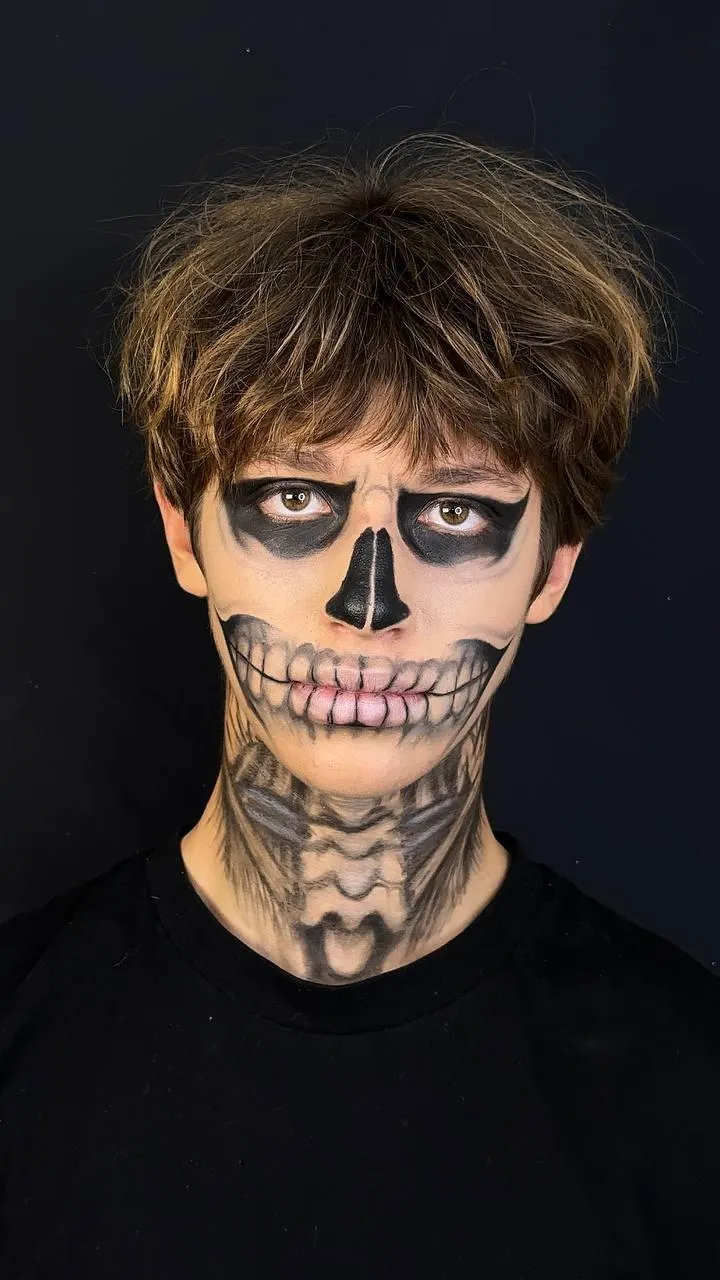 Young Person with Skull Face Paint for Halloween Wallpaper